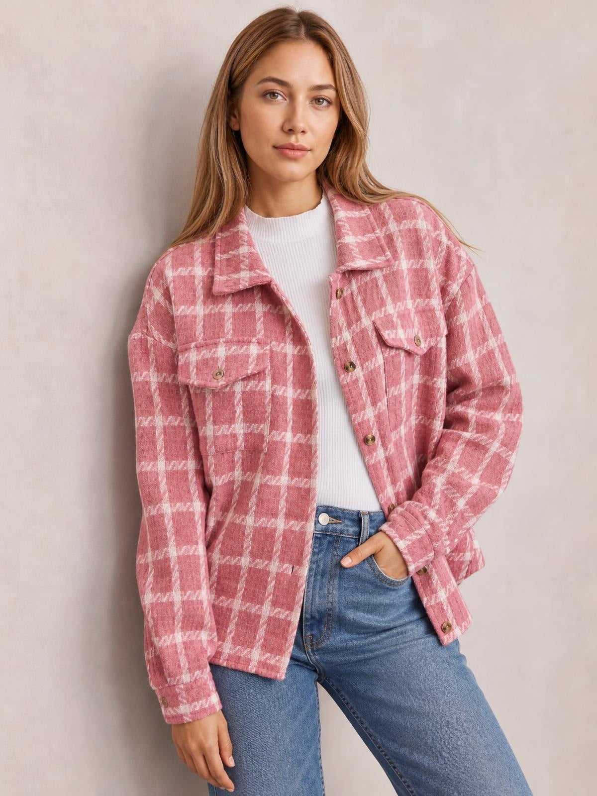 Model wearing a pink and white plaid button-up long sleeve jacket with a relaxed silhouette, pointed collar, front buttons, and flap pockets.