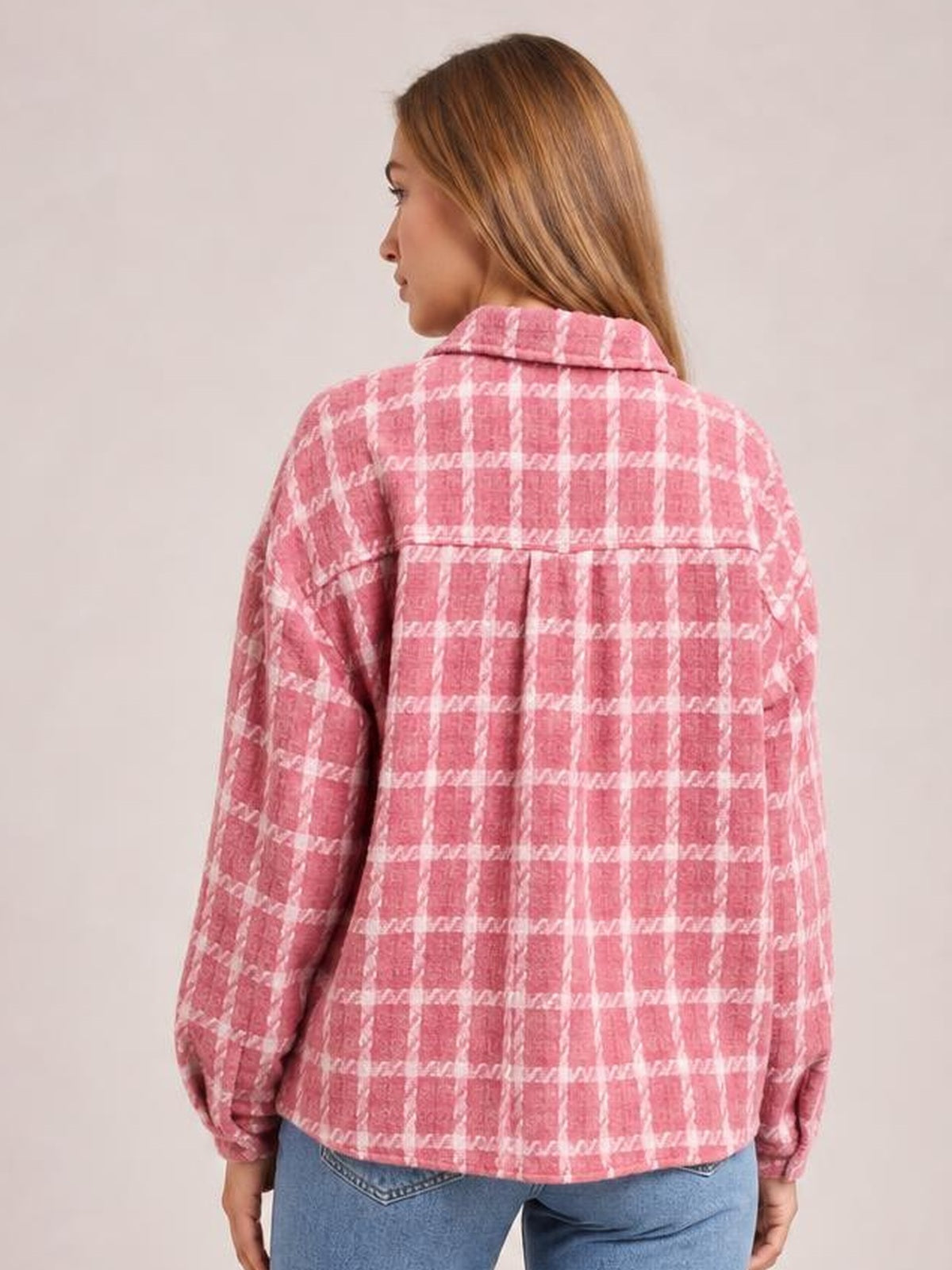 Model shown from the back wearing a pink plaid button-up long sleeve jacket with a collared neckline, relaxed silhouette, and straight hem.
