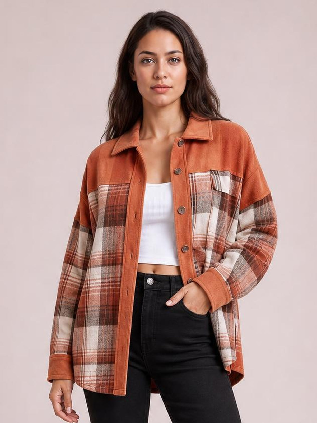 Model wearing a rust-orange plaid button-up long sleeve jacket with a relaxed silhouette, pointed collar, front buttons, and chest pockets.