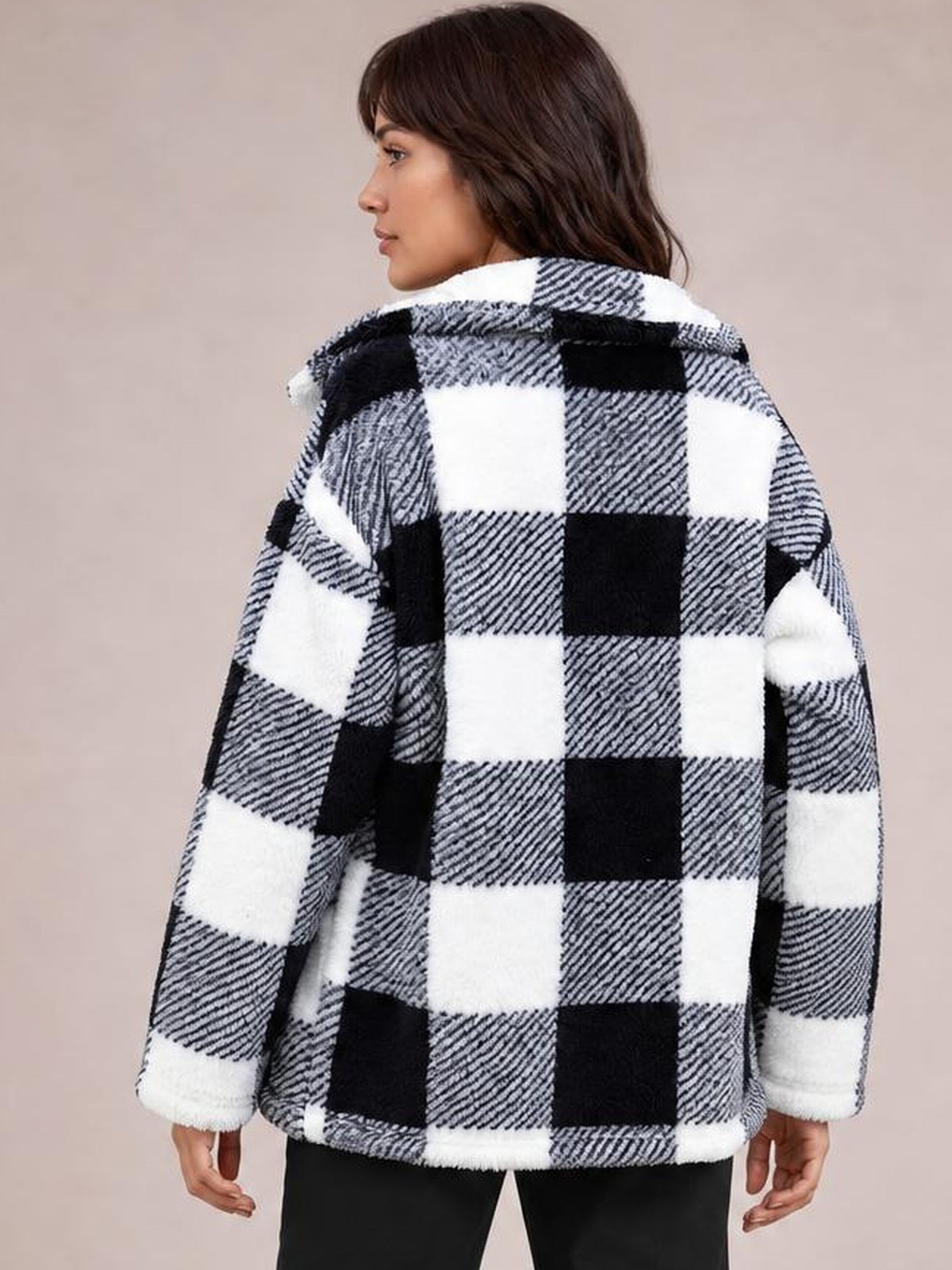 Model shown from behind wearing a black-and-white plaid collared button-down jacket with long sleeves and a relaxed, boxy silhouette.