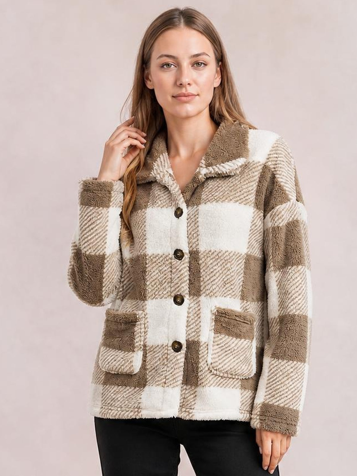 Model poses wearing a taupe and cream plaid collared button-down jacket with a relaxed silhouette, long sleeves, front buttons, and two patch pockets.