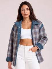 A woman models a relaxed blue and brown plaid patchwork jacket with a corduroy collar, snap-button front, zip closure, and rolled cuffs.