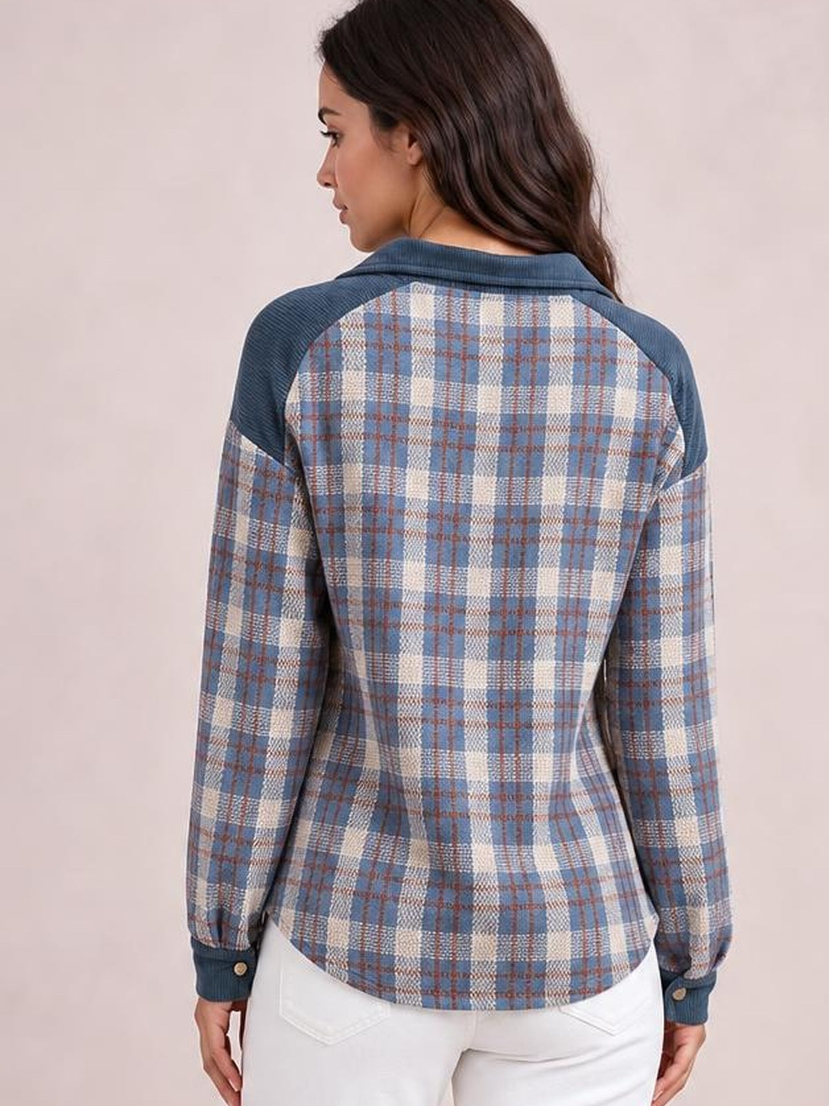 Model shown from the back wearing a blue plaid corduroy patchwork jacket with a collared neckline, long sleeves, fitted silhouette, and snap cuffs.