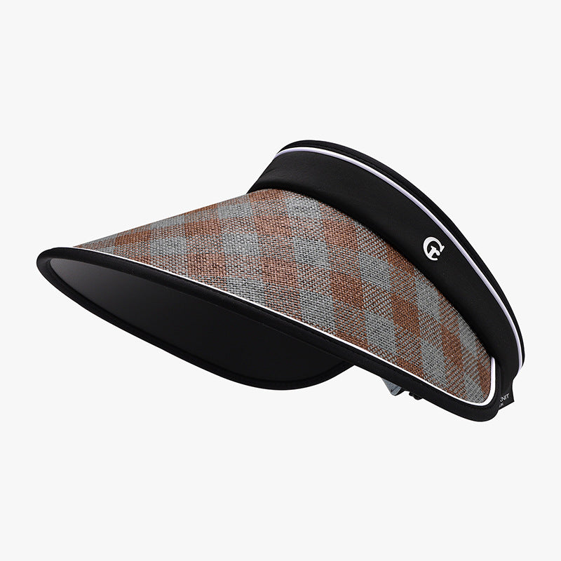 Plaid natural grass sun visor with a broad curved brim, woven brown and gray upper, black underside, contrasting trim, and adjustable back fastening.