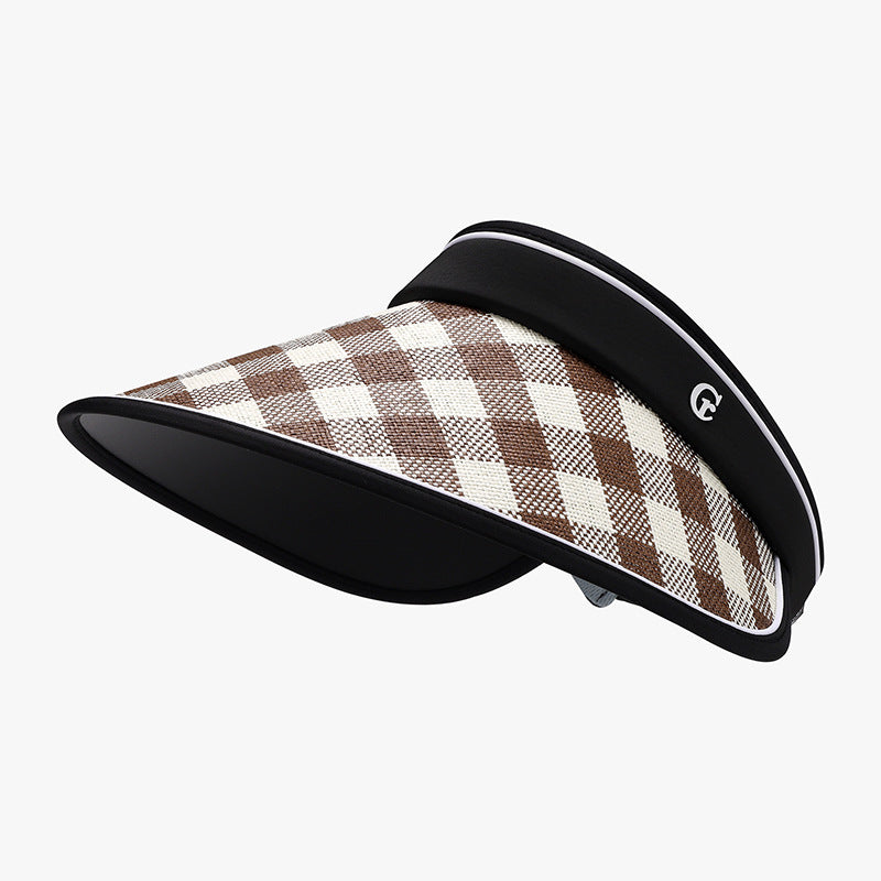 Plaid natural grass adjustable sun visor hat in brown and cream checks, featuring a structured silhouette, broad curved brim, and contrasting black trim.