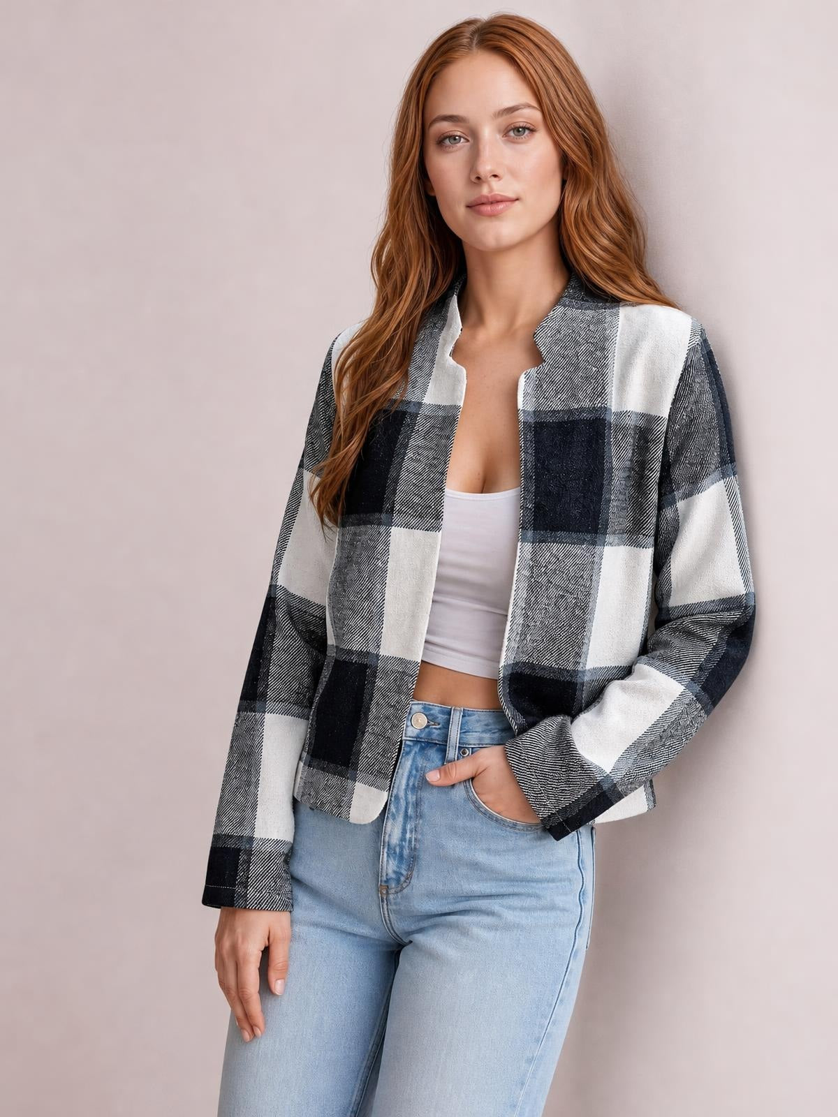 Model wears a black, white, and gray plaid open-front long sleeve jacket with a relaxed straight silhouette over a white crop top.