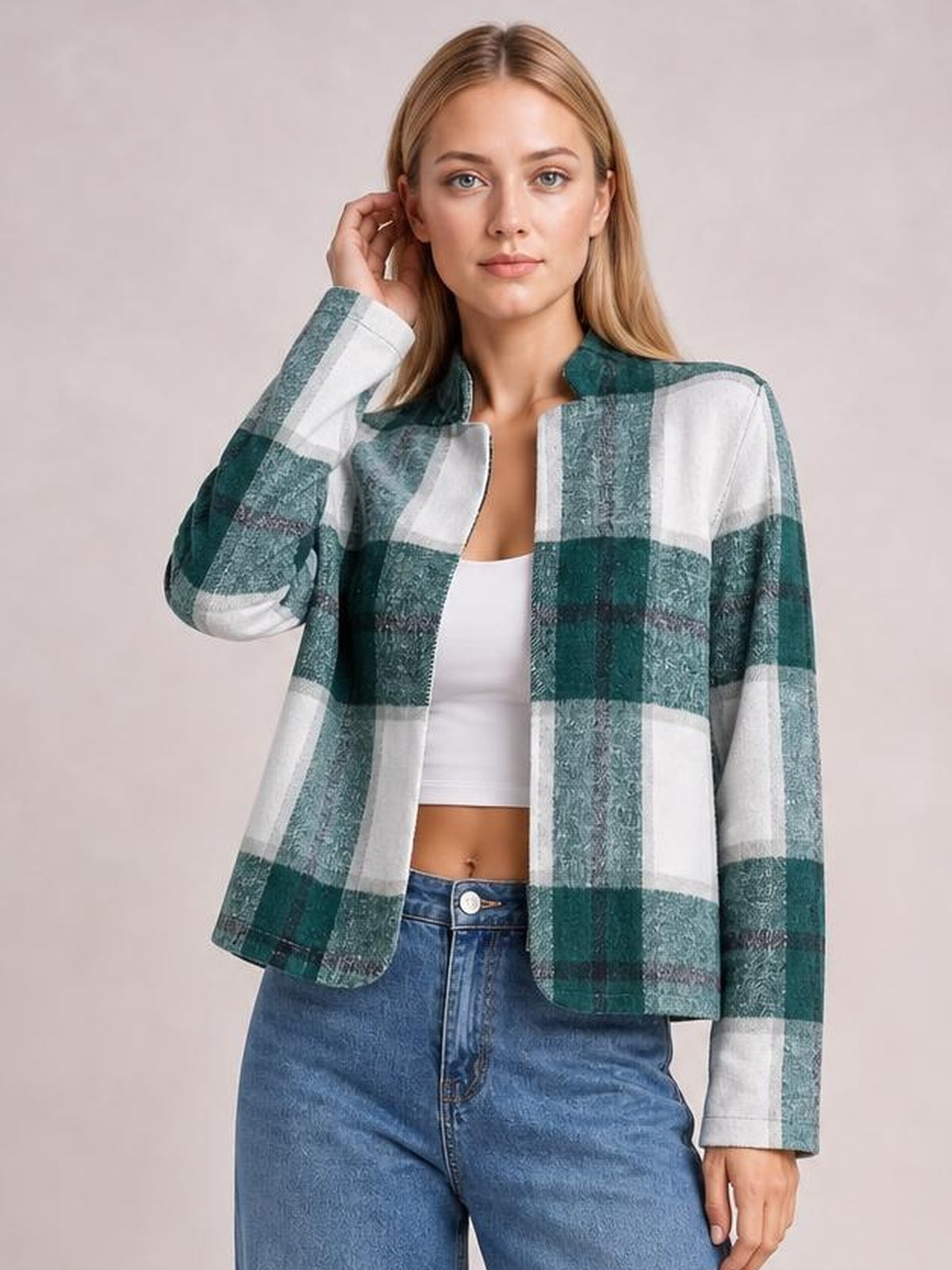 Model poses in a green and white plaid open-front long sleeve jacket with a straight silhouette, rounded neckline, and lined construction.