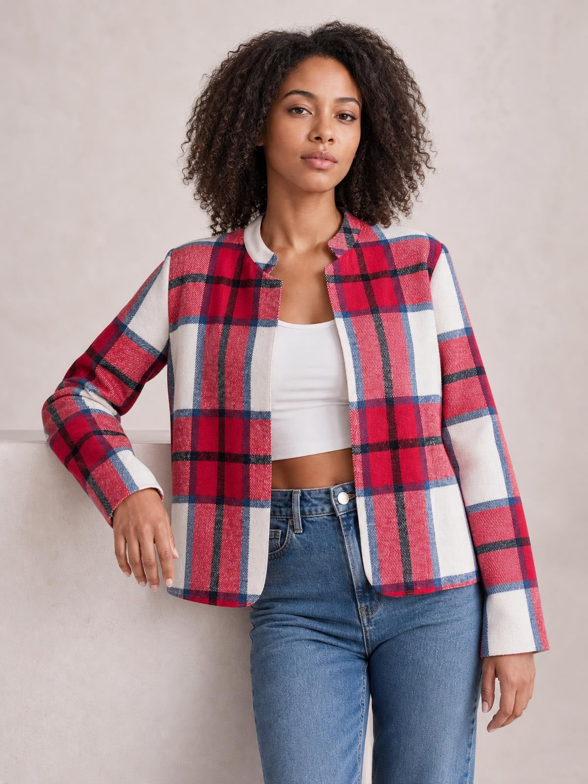 Model wearing a red, white, and blue plaid open front long sleeve jacket with a straight silhouette, rounded neckline, and lined construction.