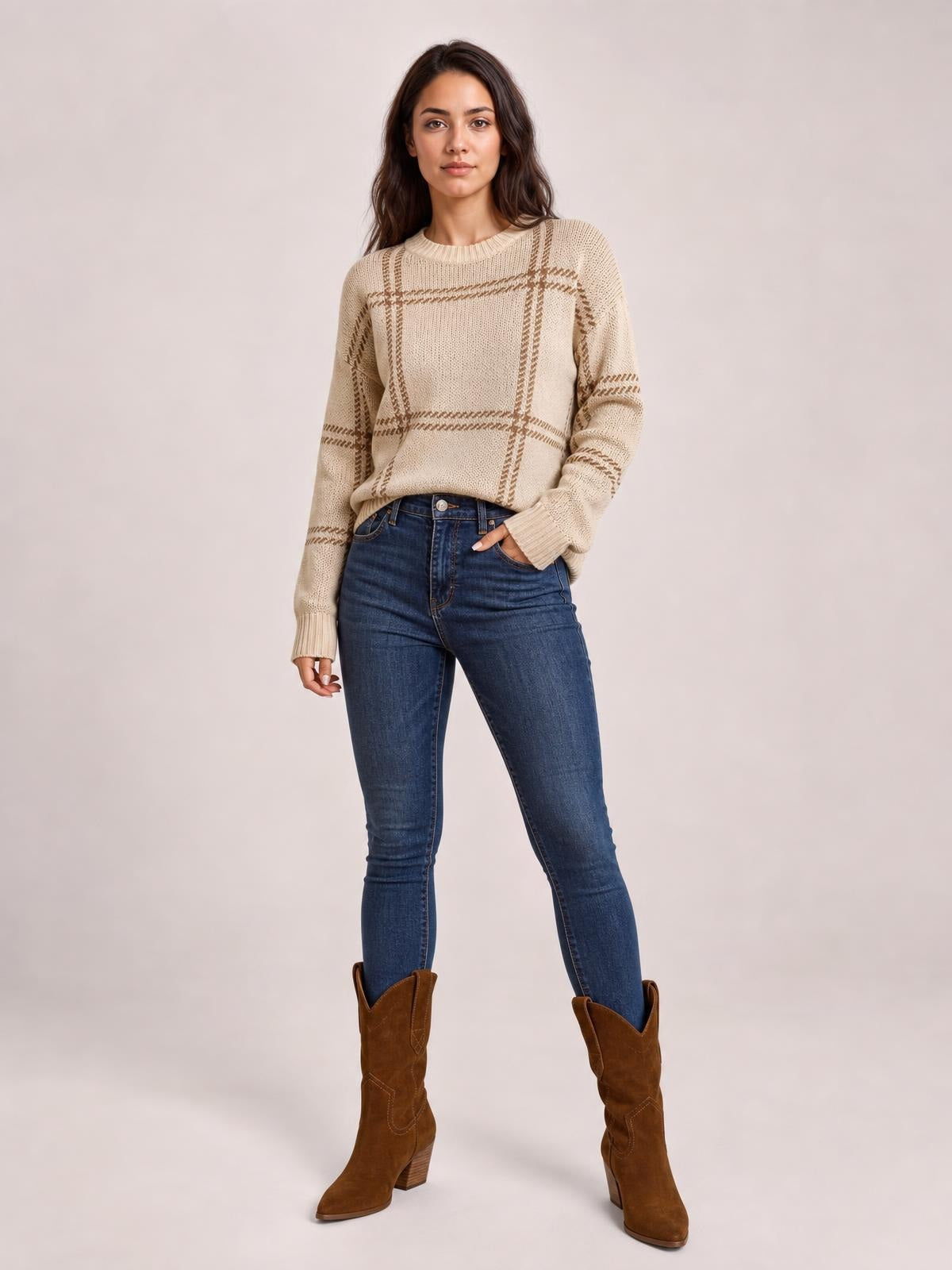 Model poses in a beige plaid round neck sweater with dropped shoulders, ribbed trim, long sleeves, and a relaxed silhouette.