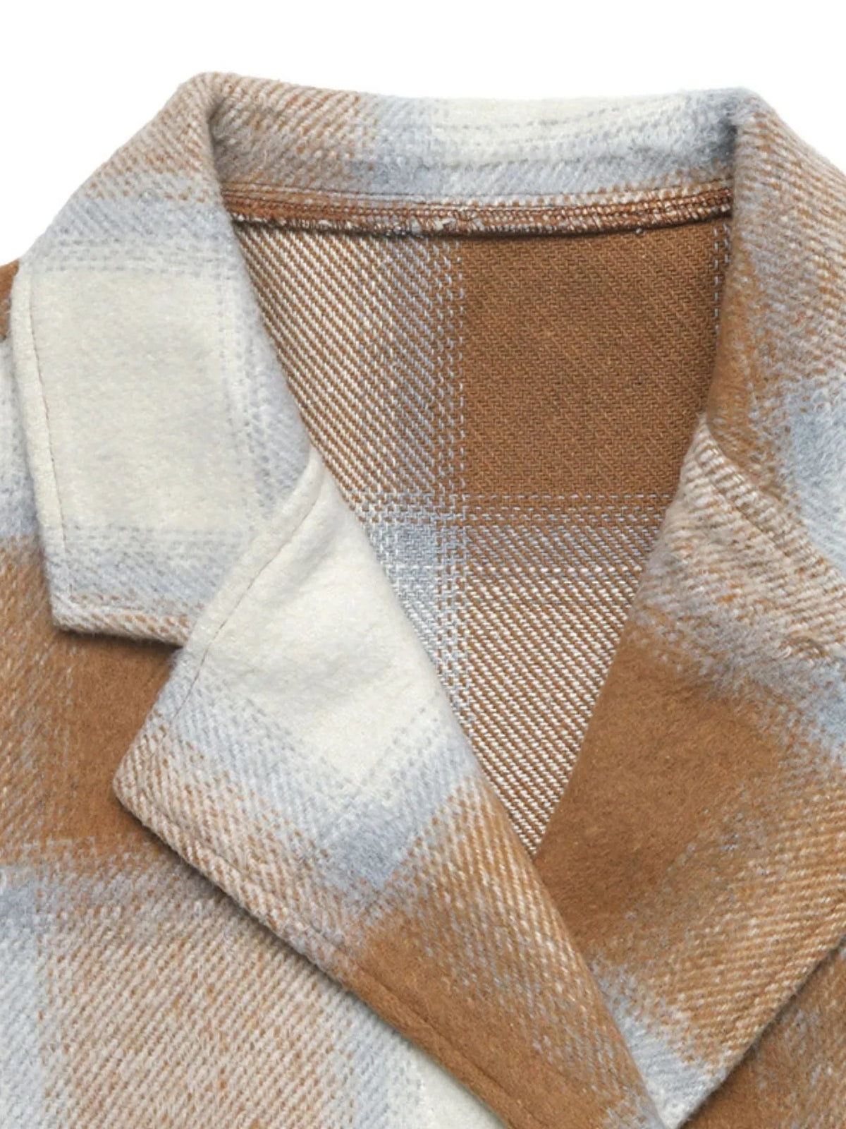 Close-up of a beige, camel, and cream plaid jacket showing a wide notched lapel, brushed woven texture, visible seams, and a brown inner panel.