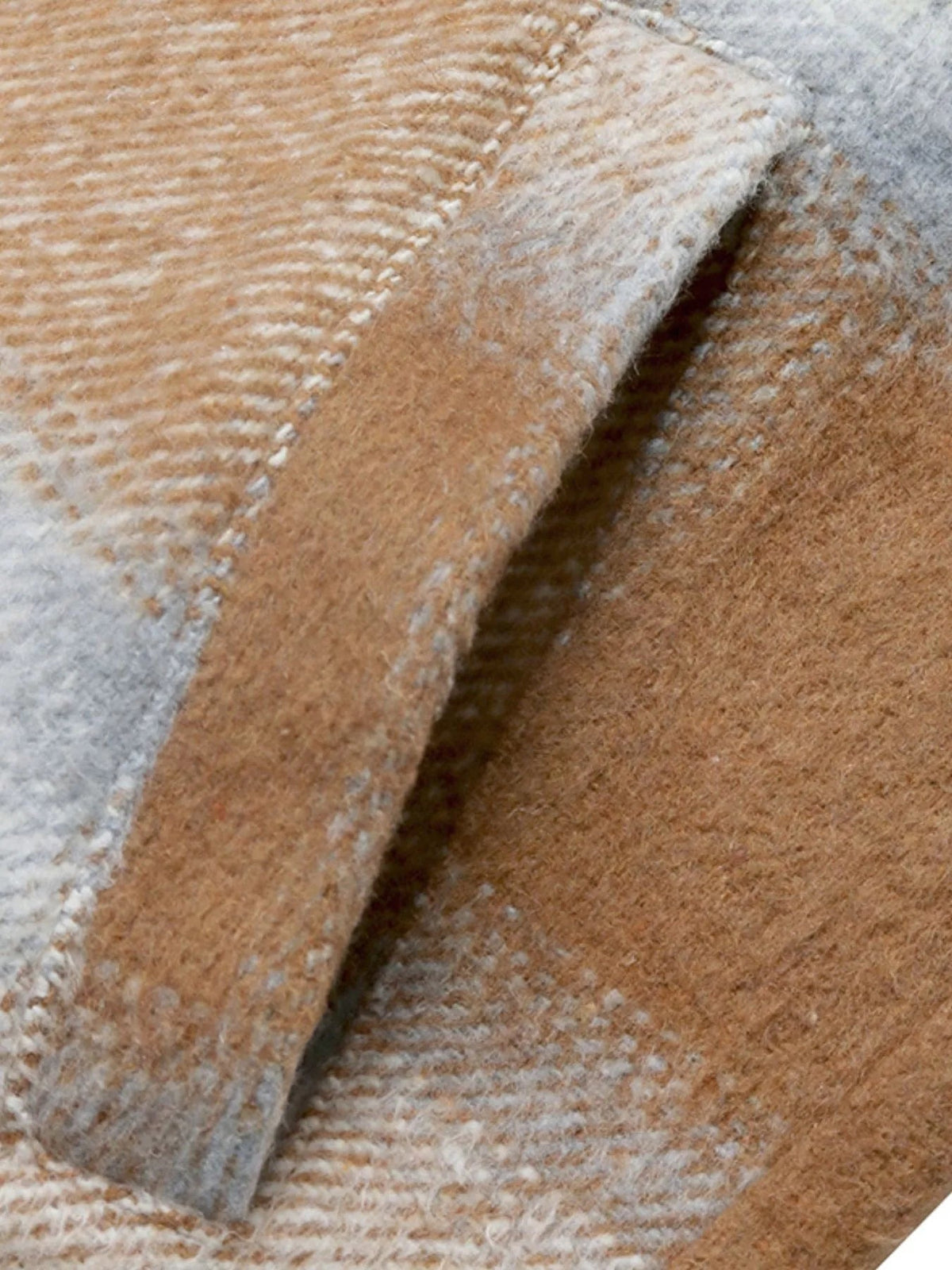 Close-up of the plaid longline jacket fabric in warm brown and gray, showing its soft, fuzzy brushed texture and woven pattern.