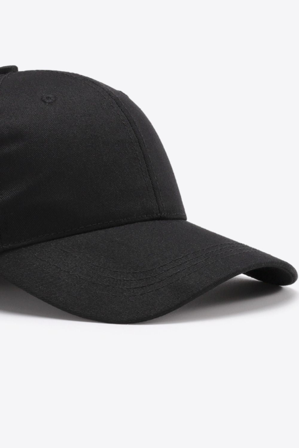 Black adjustable cotton baseball cap with a structured six-panel crown, gently curved brim, tonal stitching, and a clean solid-color finish.
