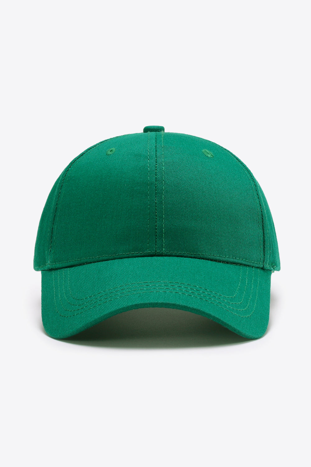 Green cotton baseball cap with a structured six-panel crown, curved brim, tonal stitching, and small ventilation eyelets.