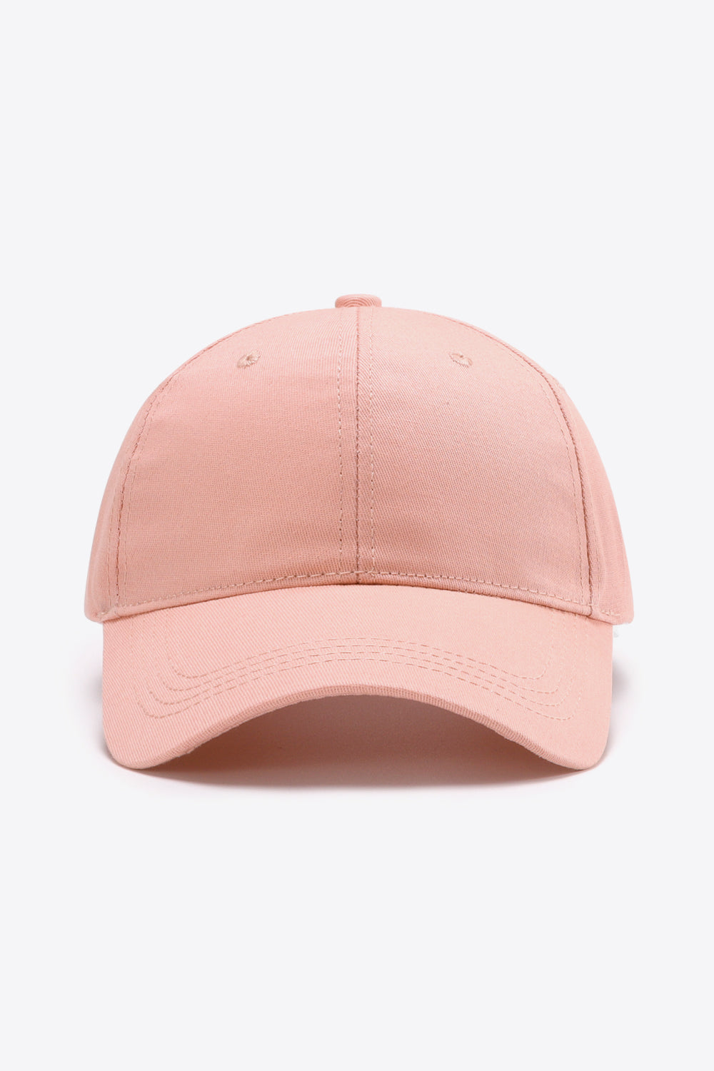 Solid pink cotton baseball cap with a structured six-panel crown, curved brim, tonal stitching, and small ventilation eyelets.
