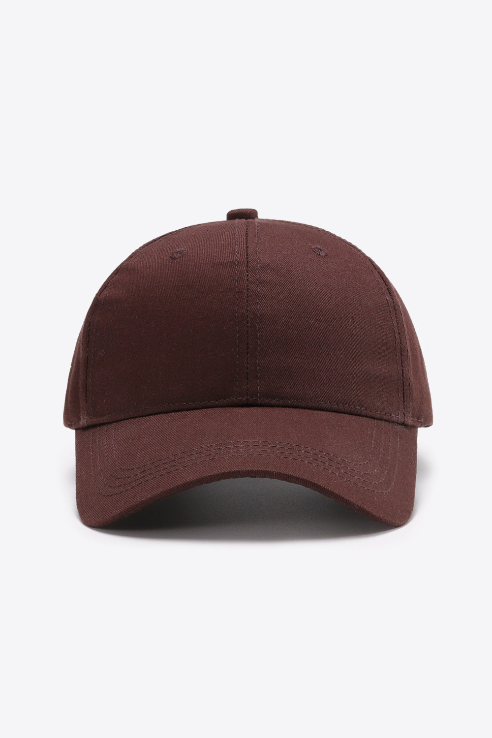 Solid brown cotton baseball cap with a structured six-panel crown, gently curved brim, tonal stitching, and small ventilation eyelets.