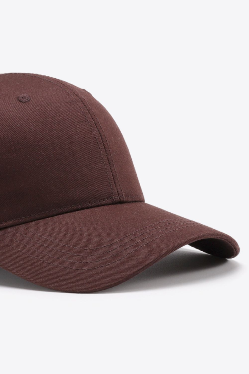 Solid brown cotton baseball cap with a structured six-panel crown, gently curved brim, tonal stitching, and a clean understated finish.