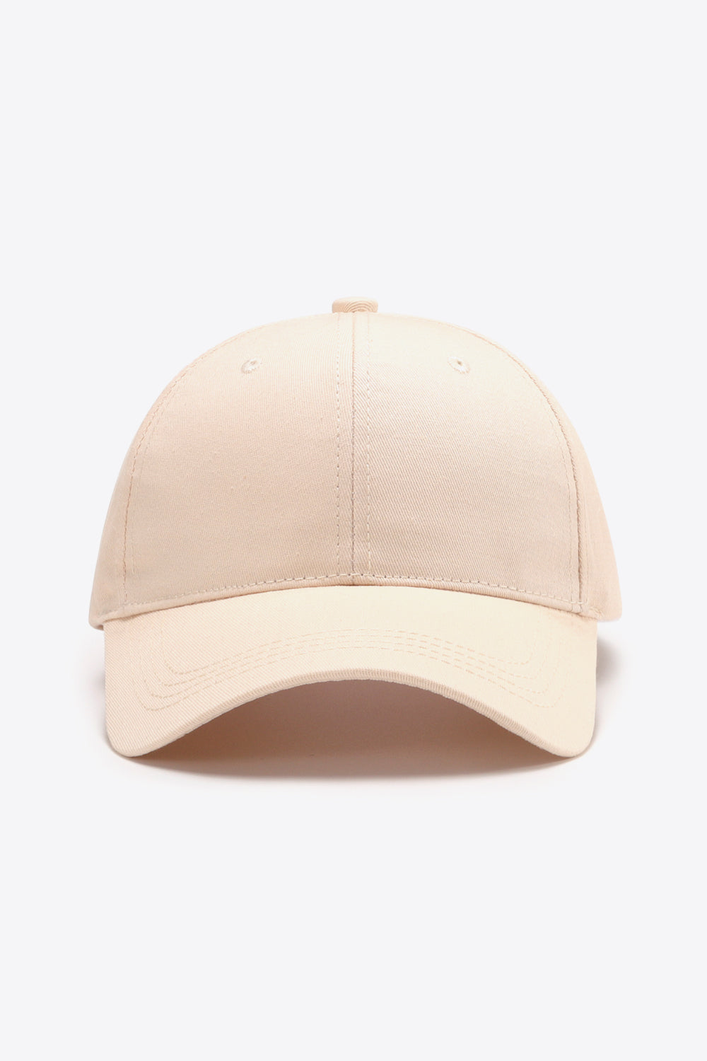 Solid beige cotton baseball cap with a structured six-panel crown, gently curved brim, tonal stitching, ventilation eyelets, and a classic adjustable silhouette.