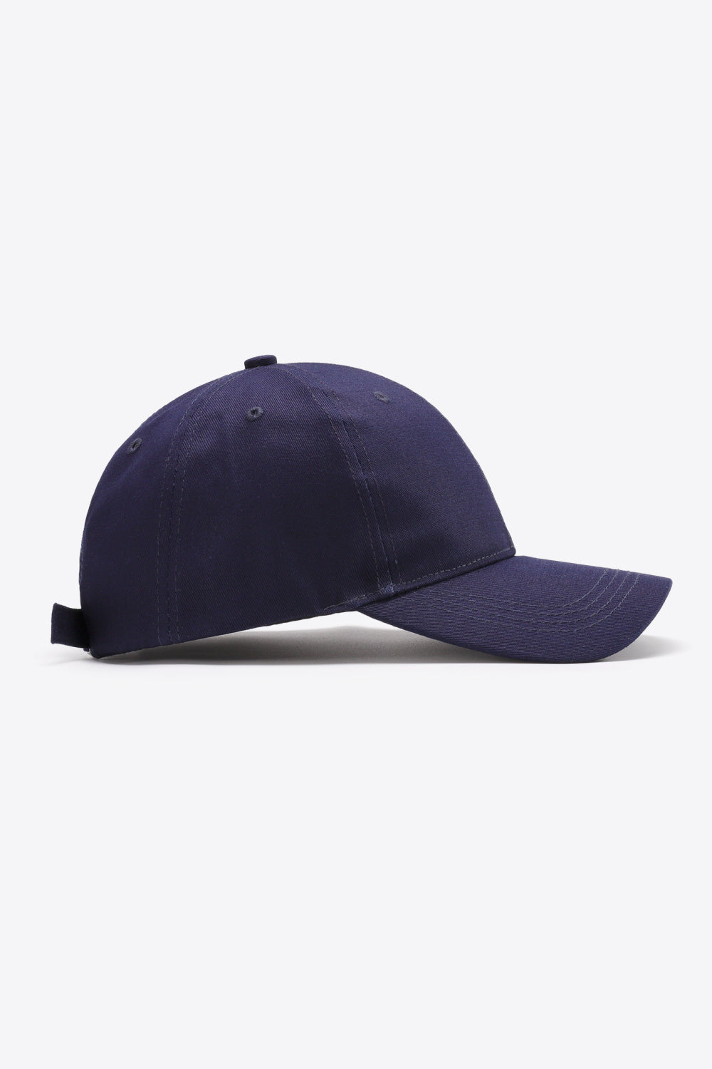 A solid navy cotton baseball cap with a structured six-panel crown, gently curved brim, tonal stitching, ventilation eyelets, and adjustable back strap.