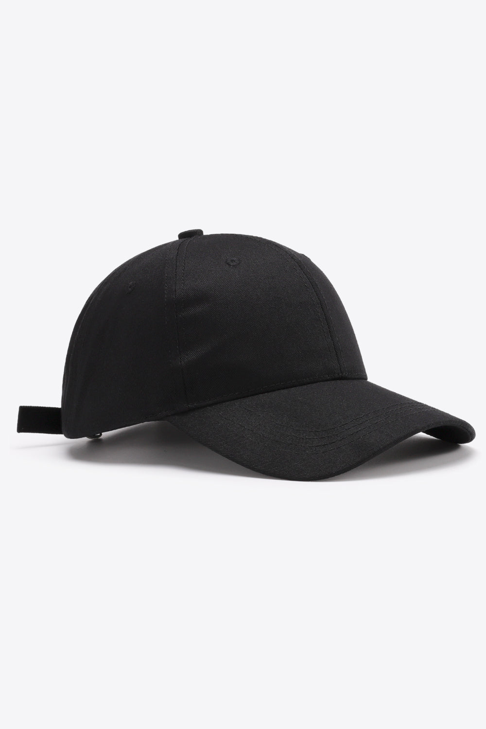 Plain black adjustable cotton baseball cap with a structured six-panel crown, gently curved brim, tonal stitching, ventilation eyelets, and back strap.