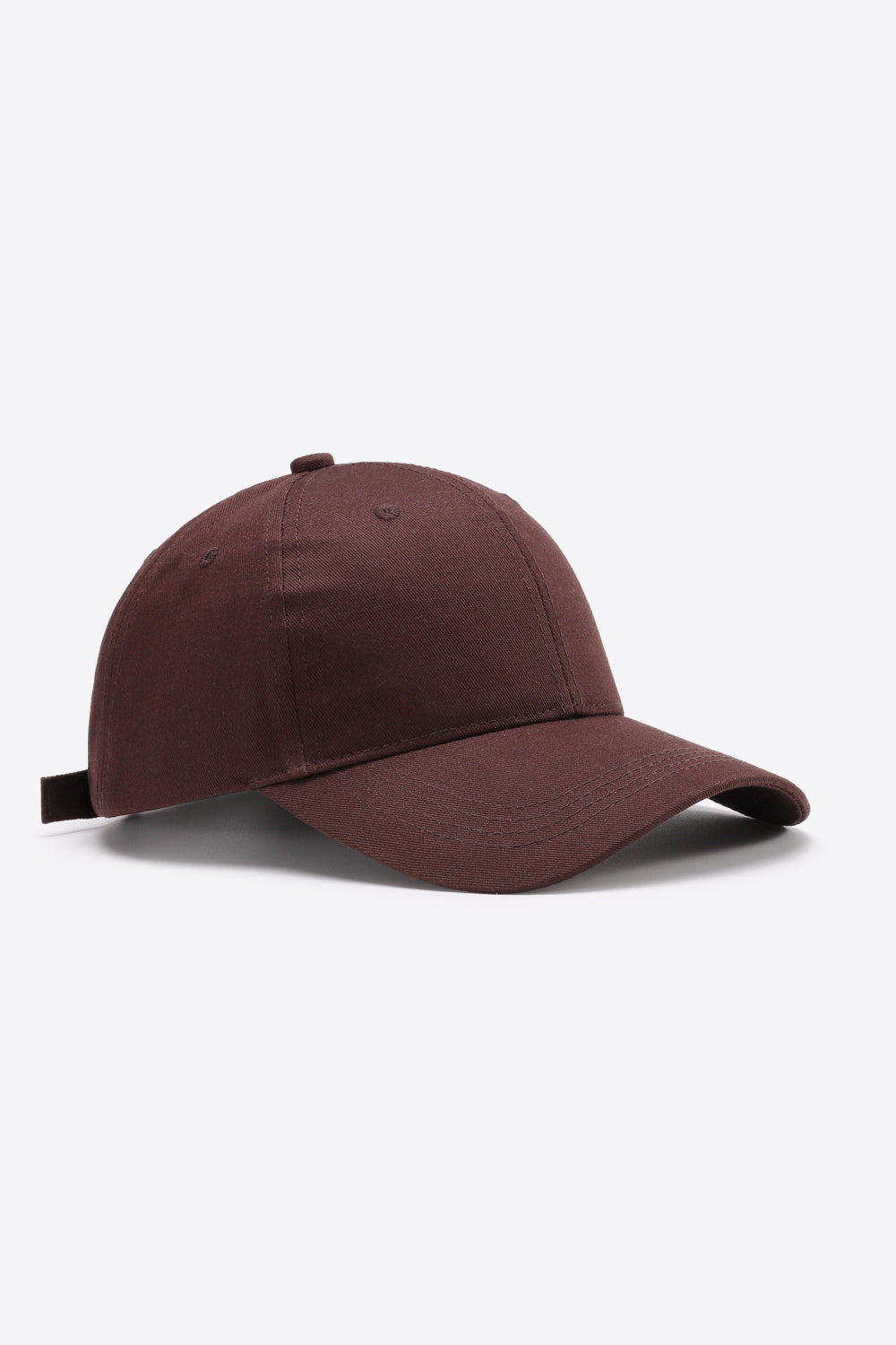 Solid brown cotton baseball cap with a structured six-panel-inspired crown, curved brim, tonal stitching, ventilation eyelets, and an adjustable back strap.