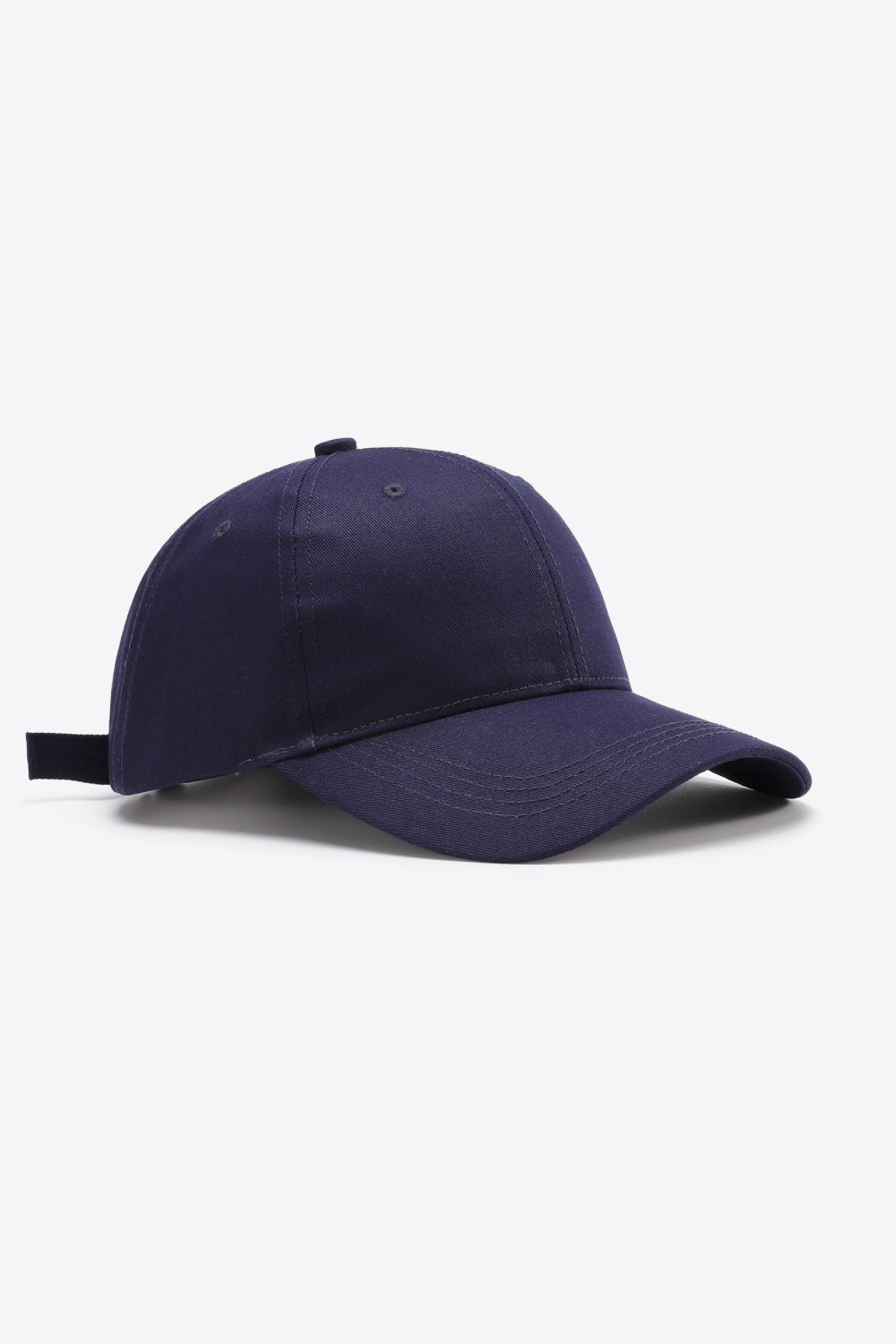 Solid navy cotton baseball cap with a structured six-panel crown, gently curved brim, tonal stitching, ventilation eyelets, and an adjustable back strap.