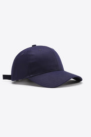 Solid navy cotton baseball cap with a structured six-panel crown, gently curved brim, tonal stitching, ventilation eyelets, and an adjustable back strap.