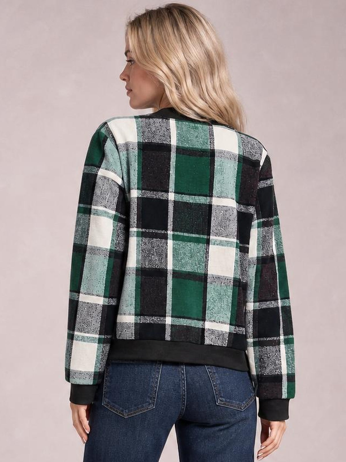 Model shown from behind wearing a green, black, and white plaid zip-up jacket with a baseball collar, long sleeves, ribbed cuffs, and a black hem.
