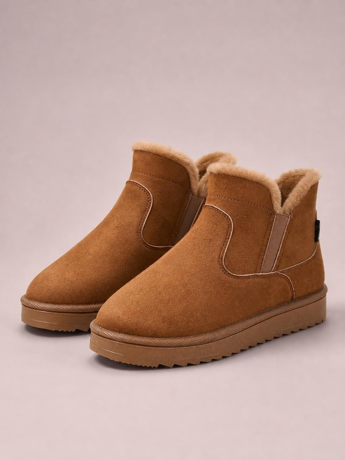 Brown suede winter ankle boots with plush lining, flat heels, stitched panels, elastic side inserts, and durable rubber lug soles.