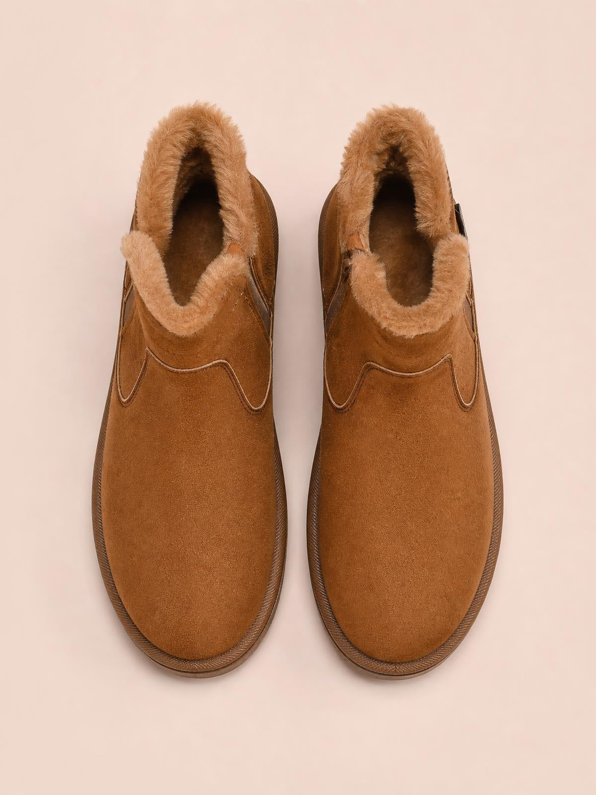 Brown suede winter ankle boots with plush lining, rounded toes, flat rubber soles, and decorative stitched panels.
