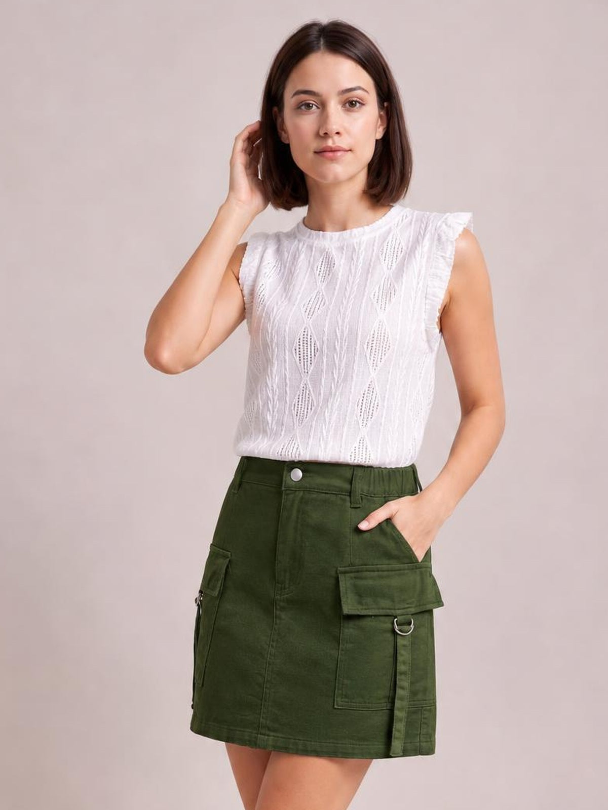 A model poses in a dark green pocketed buttoned denim skirt with a high waist, straight mini silhouette, cargo pockets, and visible seam detailing.