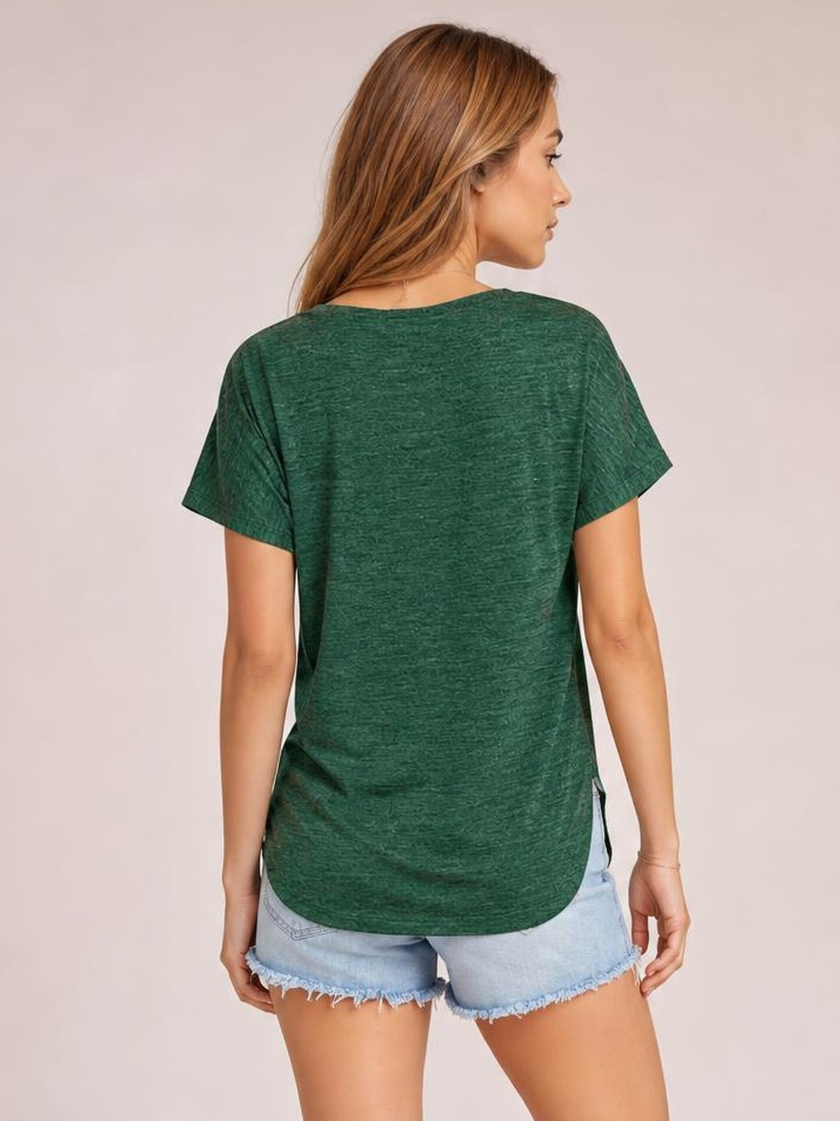 A model shown from the back wears a green heathered short-sleeve T-shirt with a relaxed silhouette, straight side seams, and a rounded hem.
