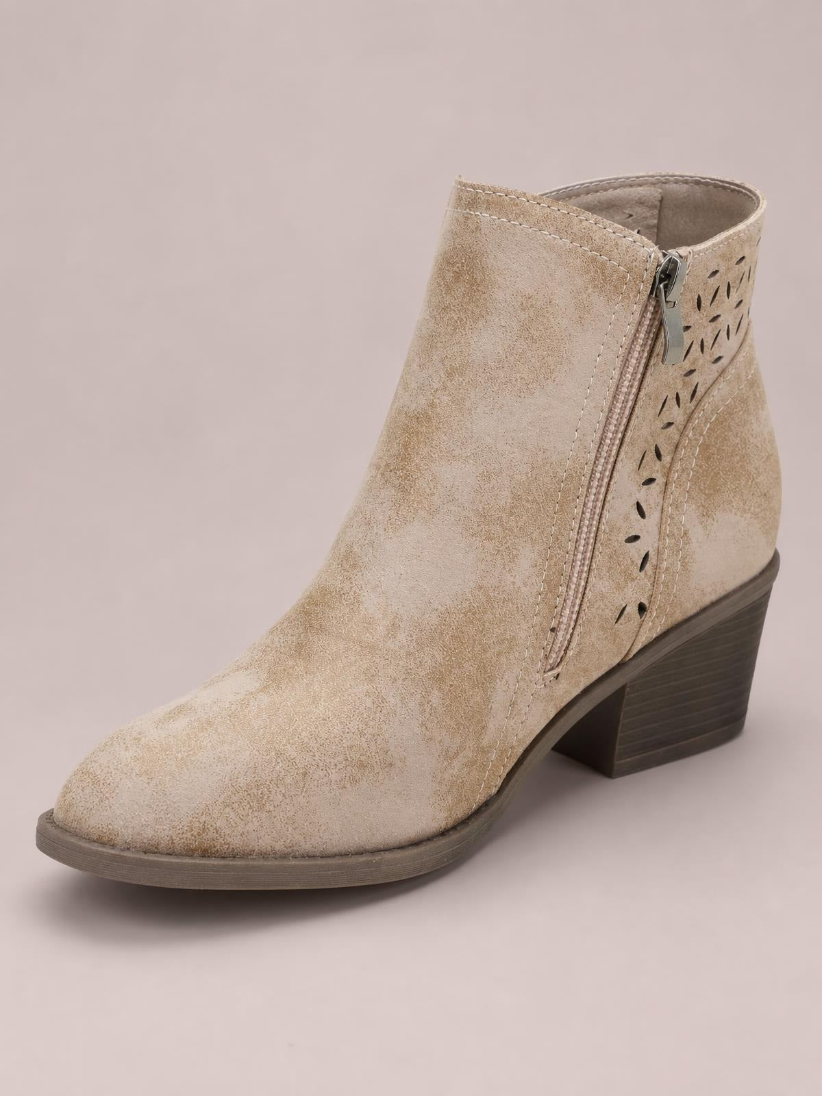 A beige PU leather ankle boot with a pointed toe, side zipper, perforated panel, stitched construction, mid-height block heel, and rubber sole.