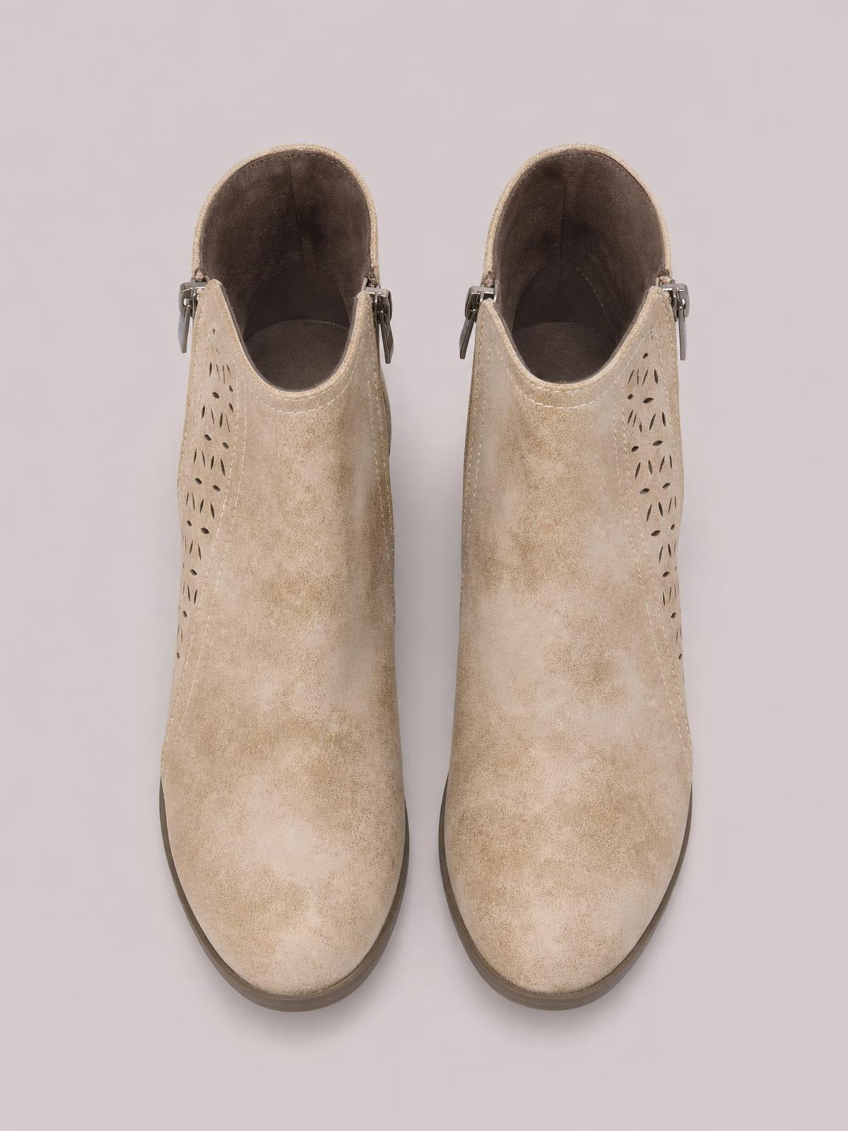 Pair of beige PU leather point-toe ankle boots with perforated side panels, exposed ankle openings, visible zipper hardware, and mid block heels.