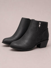 Black PU leather ankle boots feature pointed toes, mid-height block heels, side zippers, and a perforated panel for textured style.