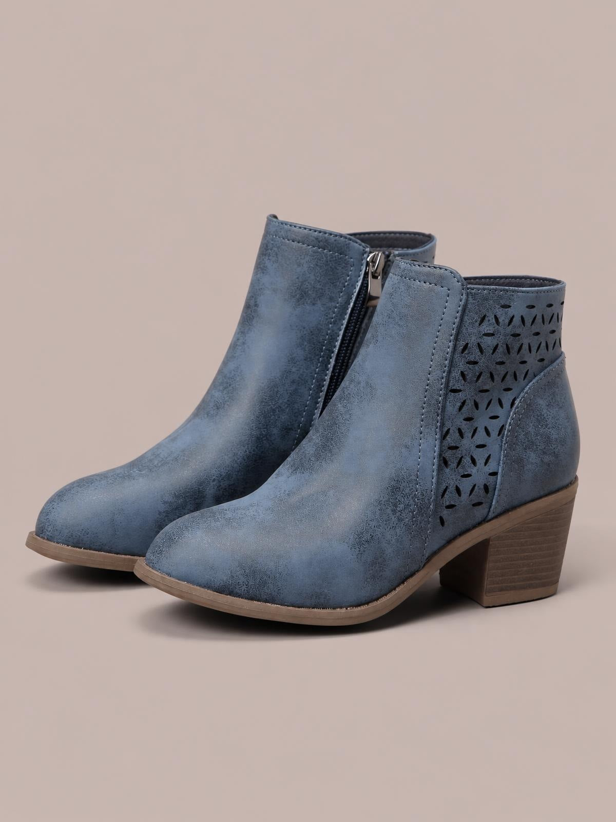 Blue-gray PU leather ankle boots feature pointed toes, side zippers, perforated panels, stitched construction, and sturdy mid-height block heels.