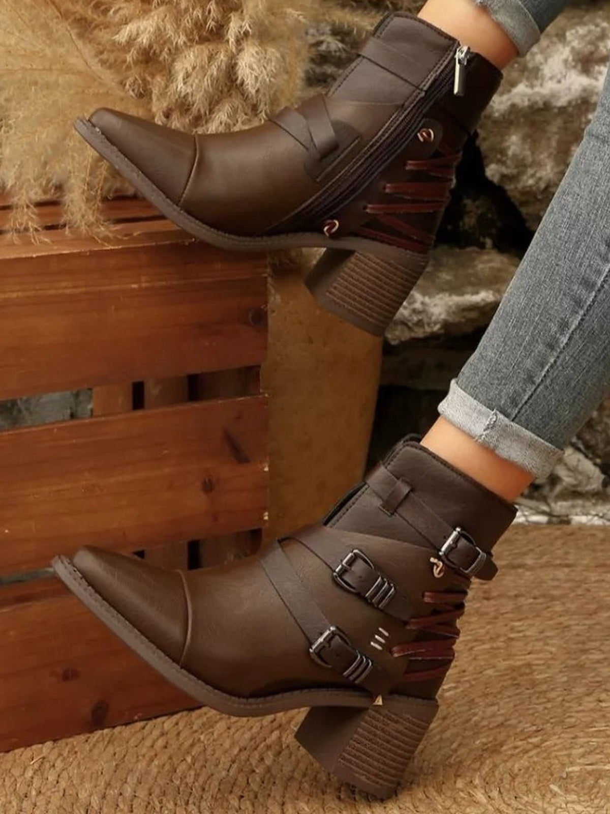 Model wears brown PU leather point-toe ankle boots with multiple buckle straps, side lacing details, and textured mid-height block heels.