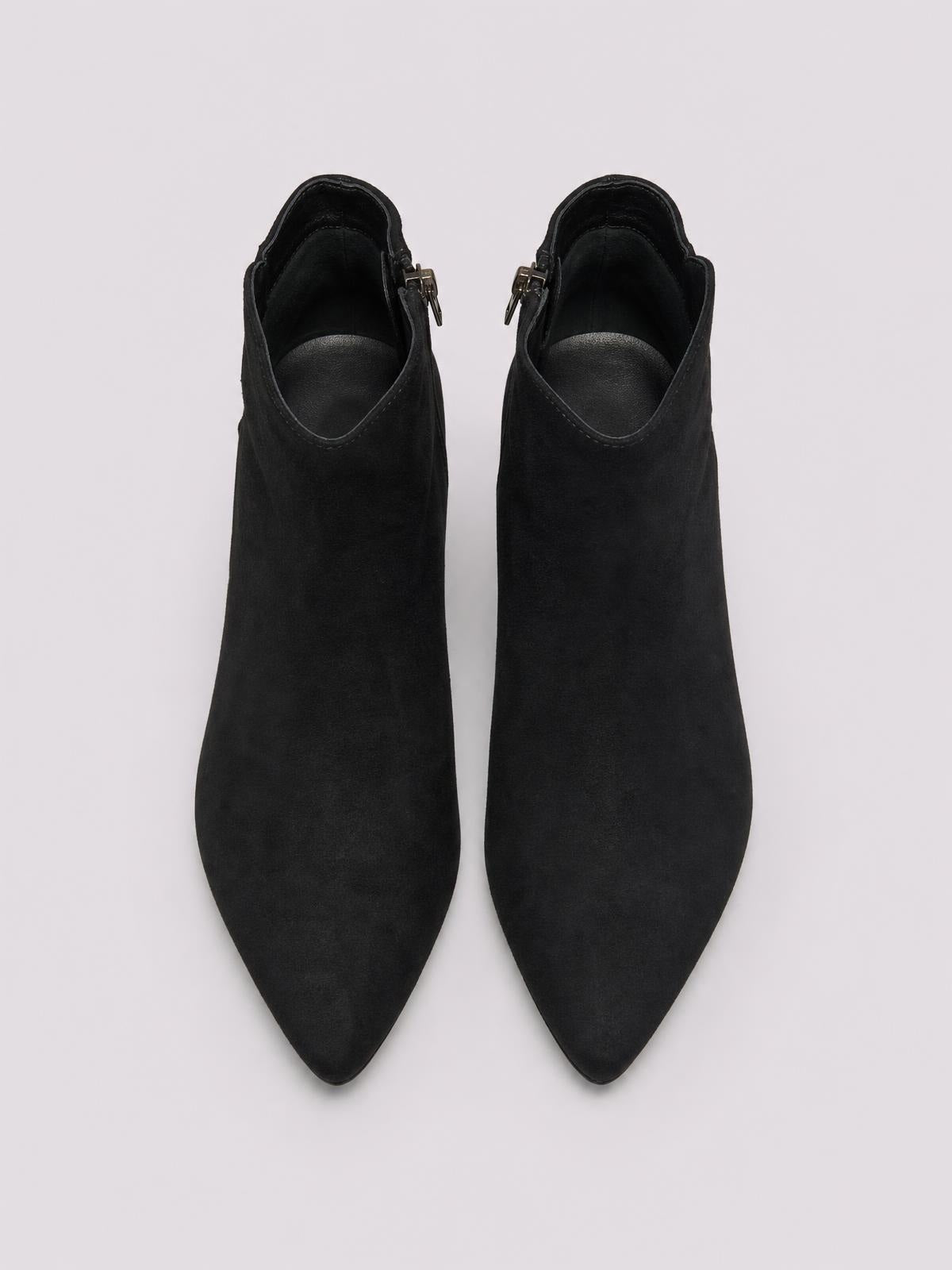 Pair of black suede ankle boots with pointed toes, low kitten heels, curved toplines, and visible side zippers.