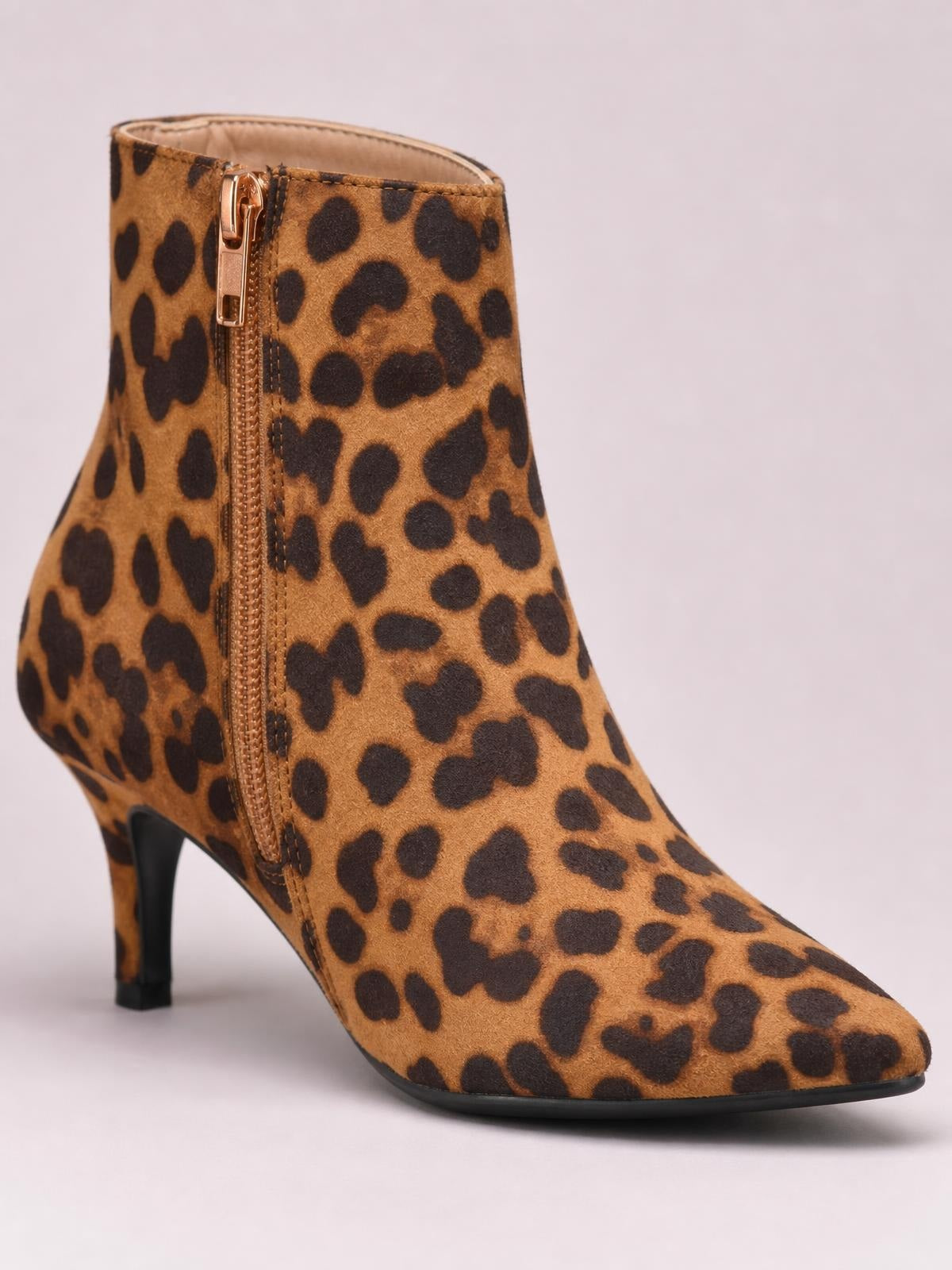 Leopard-print suede ankle boot with a pointed toe, side zipper, fitted silhouette, and slim kitten heel in warm tan and black.