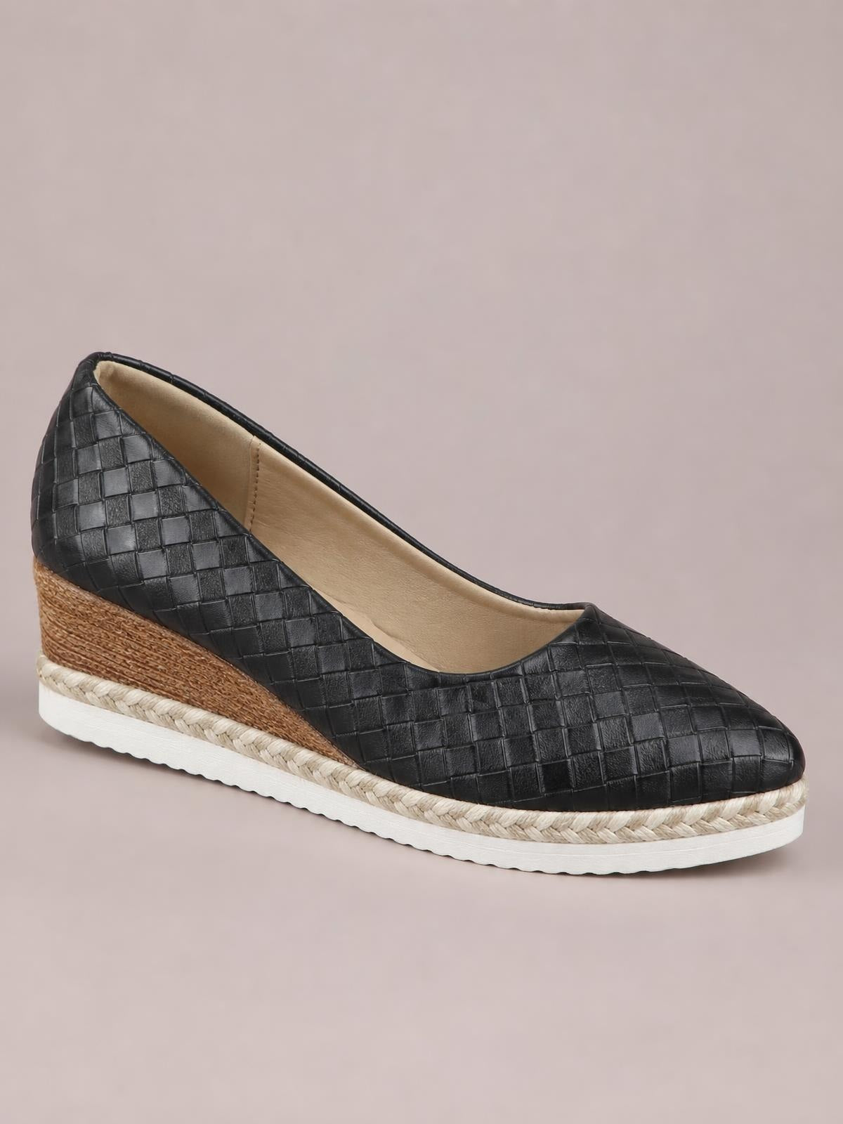 Black point-toe wedge loafers with a woven textured upper, tan espadrille-style wedge, braided trim, and white platform sole.