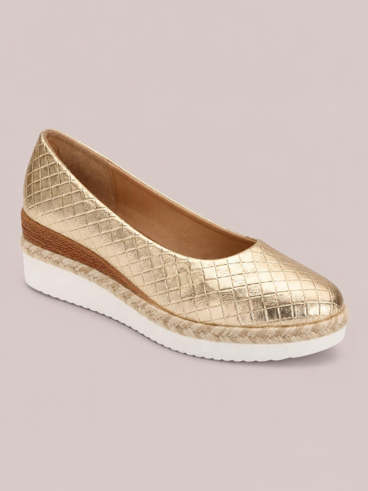 Gold point-toe wedge loafer with a quilted textured upper, low espadrille-style wedge heel, braided trim, and white platform sole.