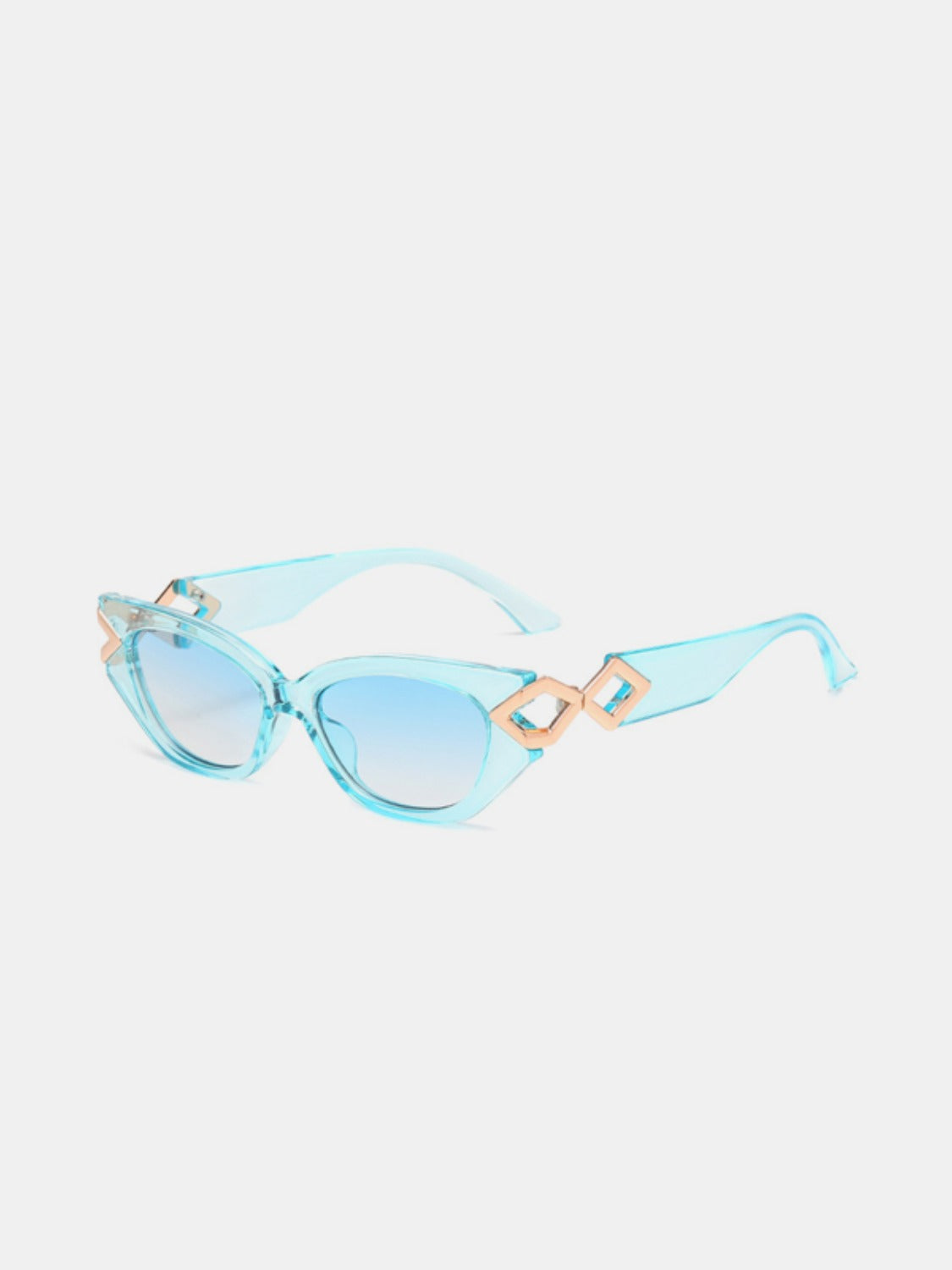 Translucent aqua polycarbonate cat-eye sunglasses feature gently upswept frames, blue gradient lenses, and sculptural gold geometric temple accents.