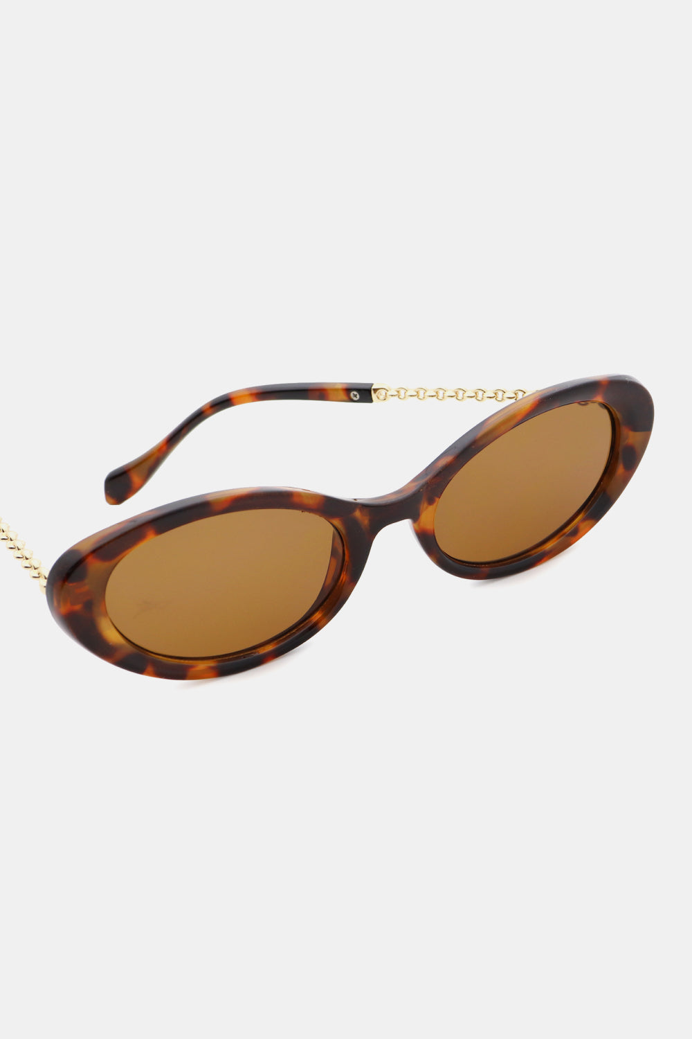 Tortoiseshell polycarbonate cat-eye sunglasses feature rounded brown lenses, a softly upswept silhouette, and contrasting gold-toned hybrid temples.