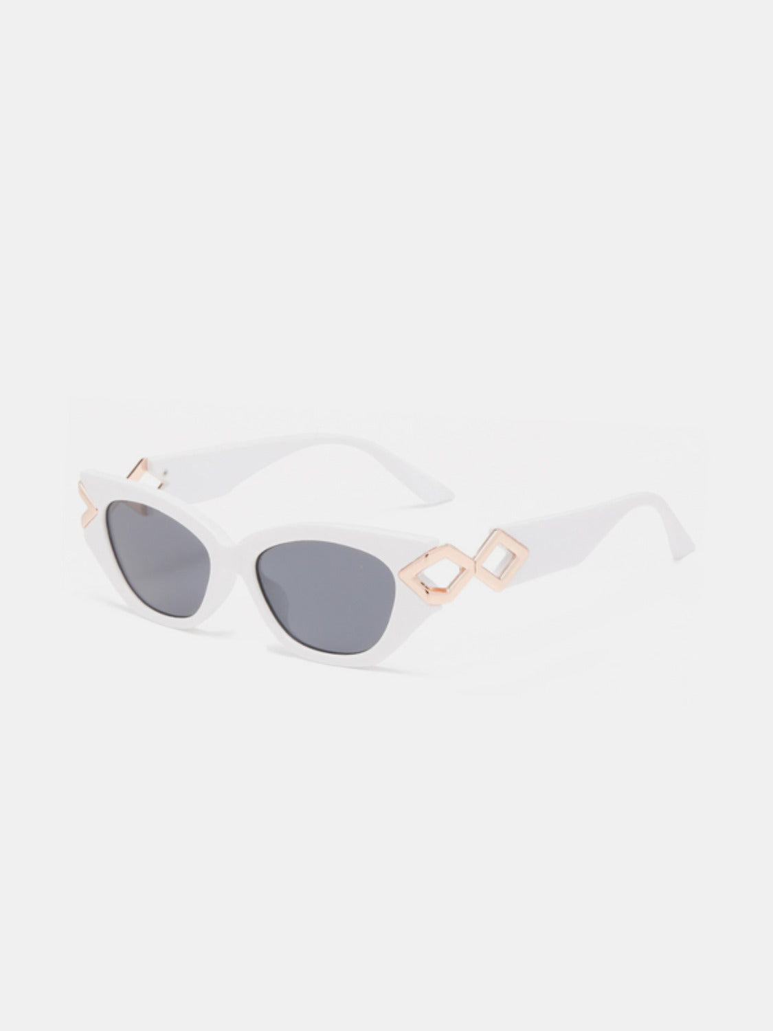 White polycarbonate cat-eye sunglasses feature dark gray lenses, a gently upswept silhouette, and sculptural geometric temple details.