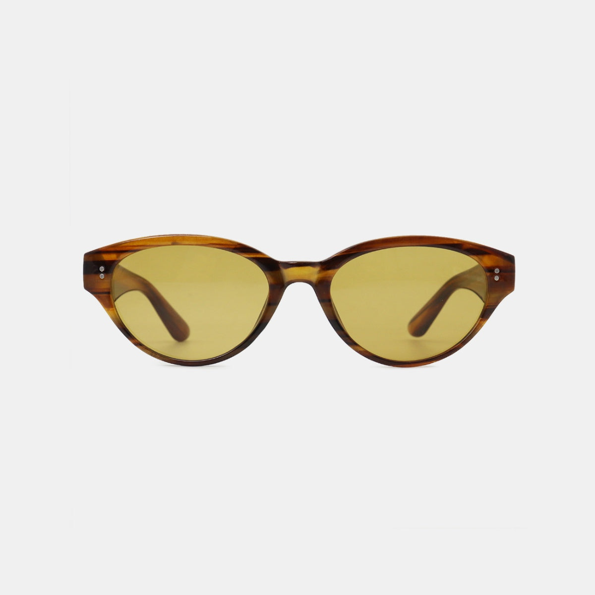 Brown tortoiseshell-style polycarbonate cat-eye sunglasses feature rounded lenses, softly upswept frames, slender temples, and warm yellow-tinted lenses.