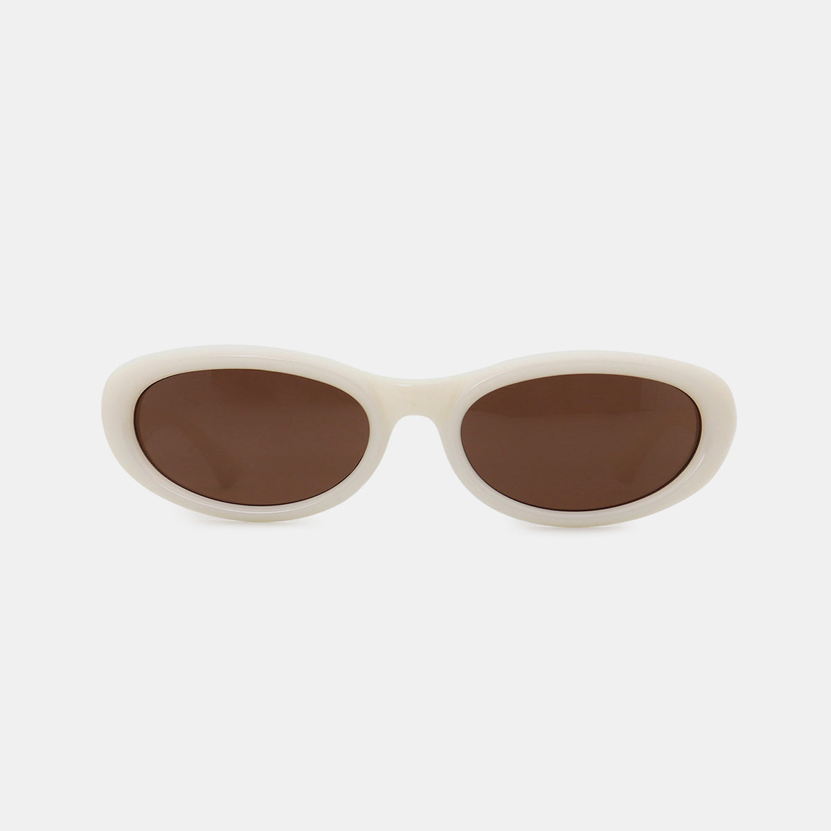 Cream polycarbonate frame cat-eye sunglasses feature softly sculpted oval brown lenses, a smooth bridge, and gently raised outer edges.