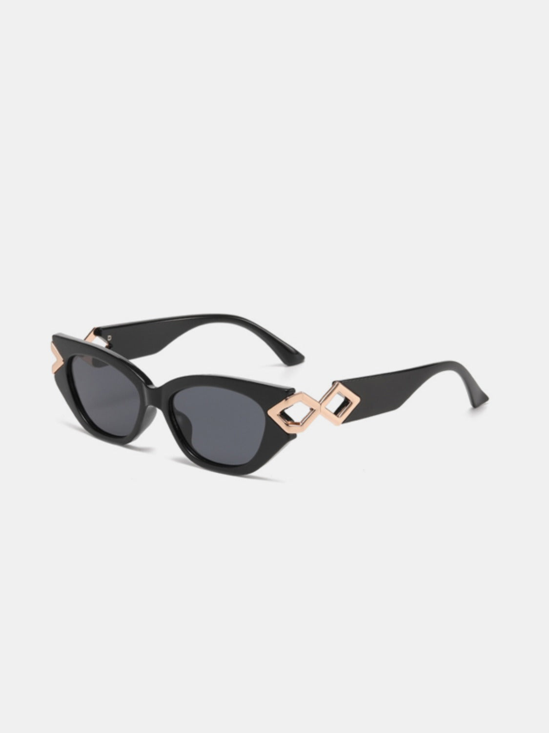 Black polycarbonate cat-eye sunglasses feature dark lenses, a gently upswept silhouette, and sculptural rose-gold geometric temple accents.