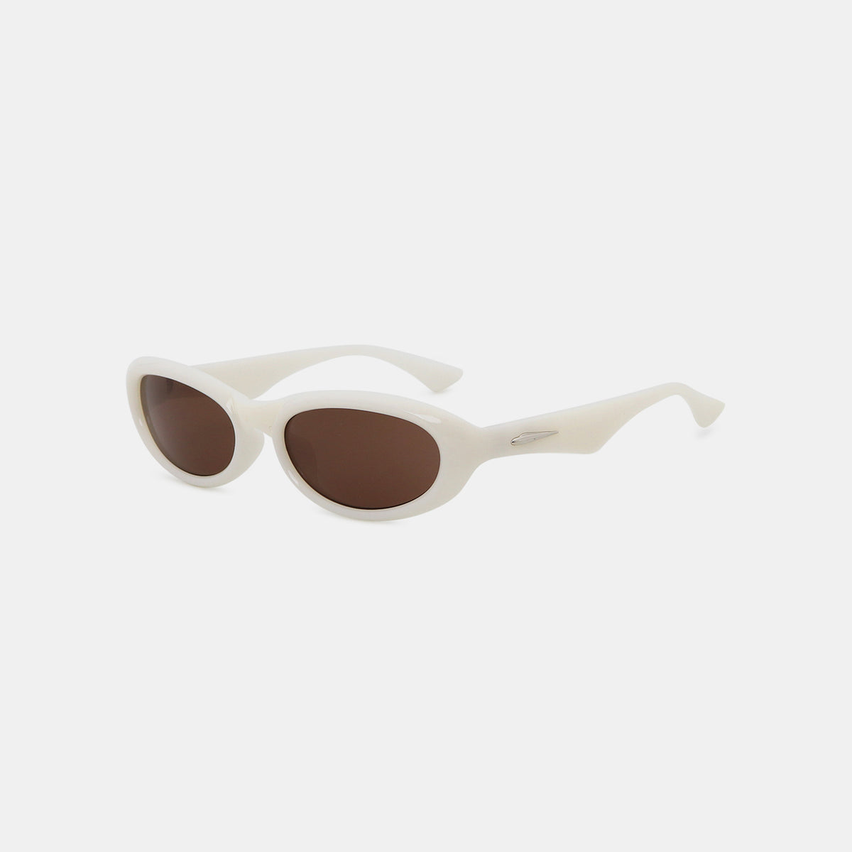 Cream polycarbonate cat-eye sunglasses feature softly sculpted brown oval lenses, raised outer edges, a smooth frame, and tapered temples shown at an angled view.