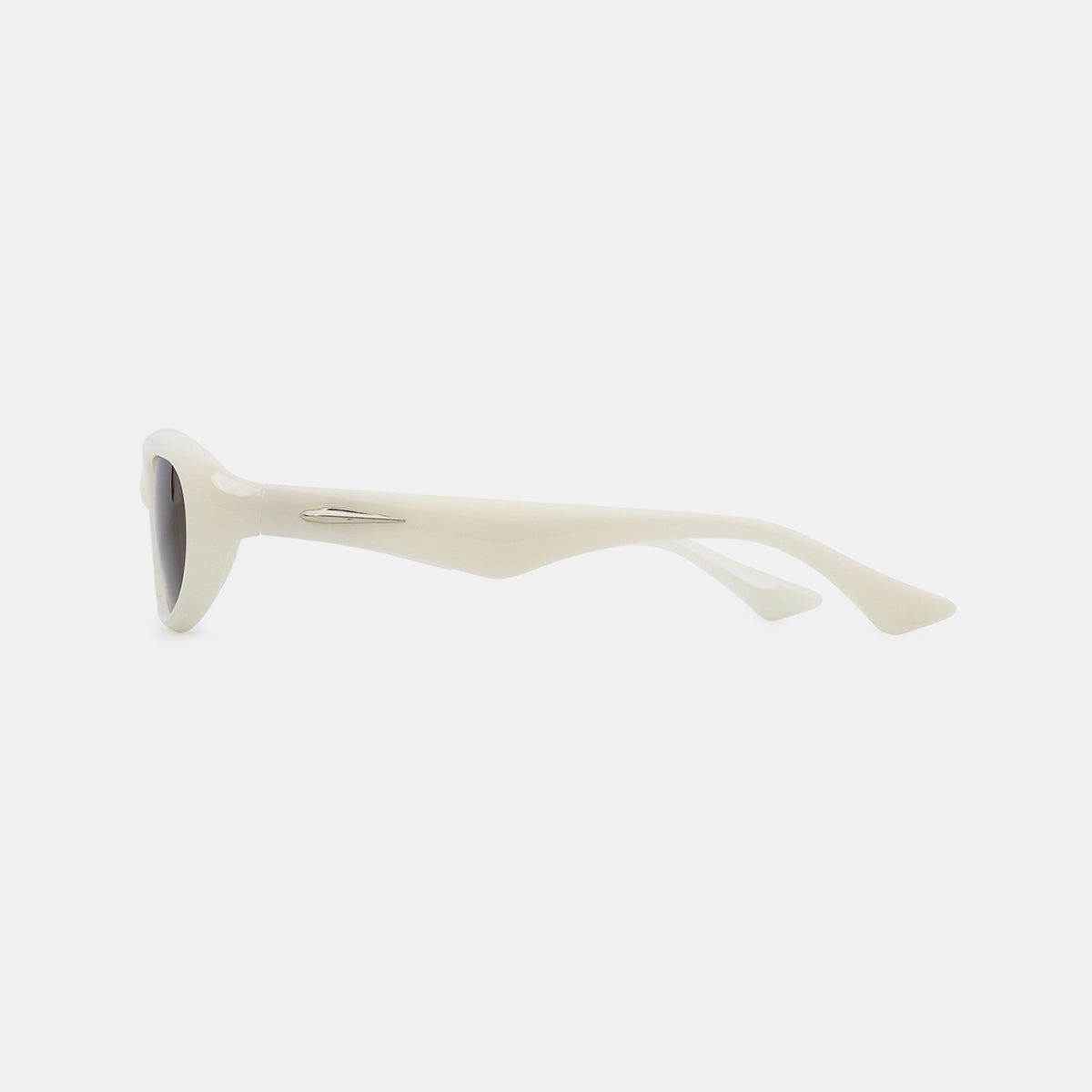 Cream polycarbonate cat-eye sunglasses shown in side profile with dark oval lenses, a gently raised outer edge, smooth frame, tapered temples, and a silver accent.