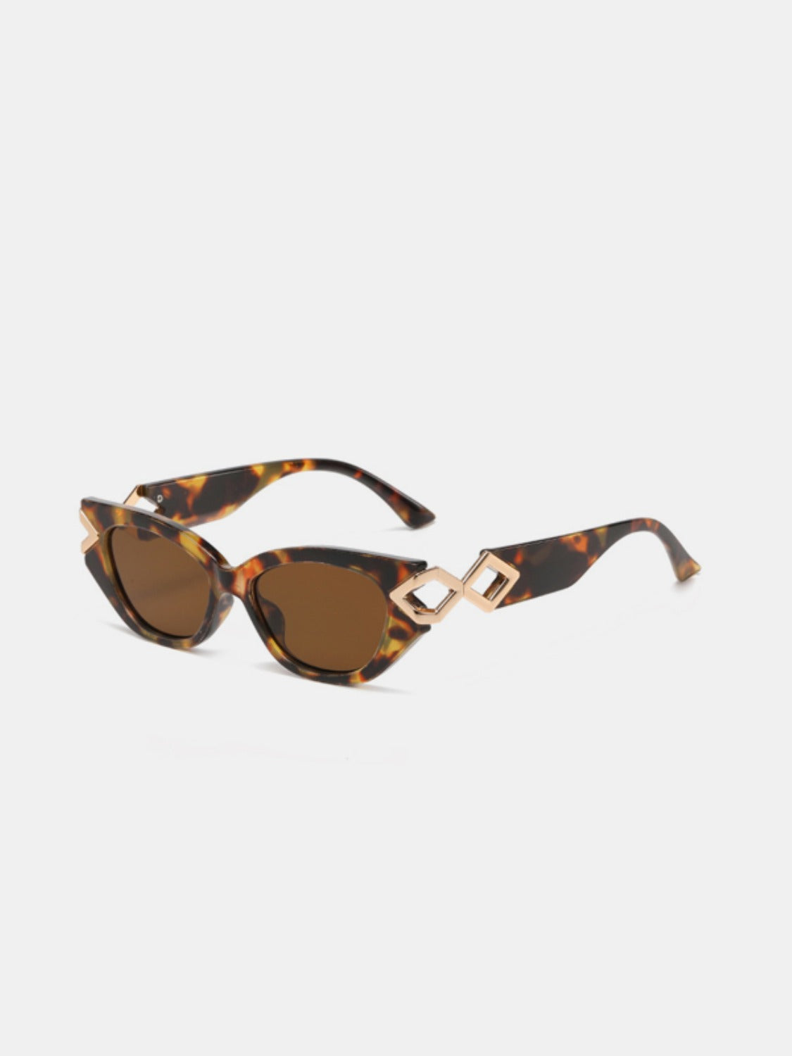 Tortoiseshell polycarbonate cat-eye sunglasses feature brown lenses, upswept frames, and sculptural gold-tone geometric temple details.