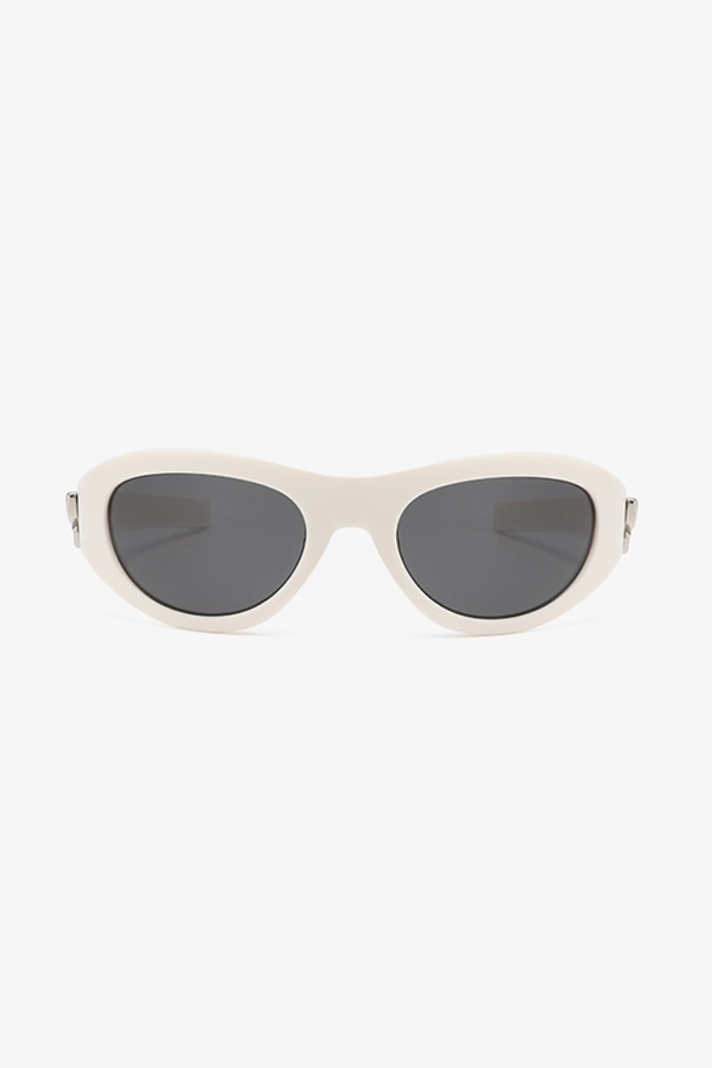 Cream polycarbonate cat-eye sunglasses feature rounded dark lenses, softly upswept outer corners, a streamlined bridge, and subtle silver-tone side detailing.